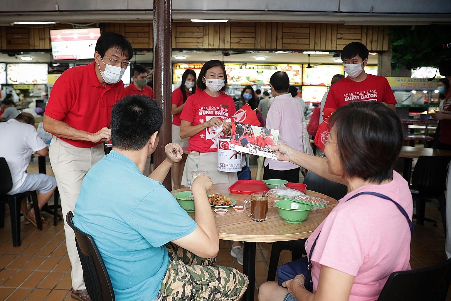 Singapore Democratic Party chief Chee Soon Juan (left) on a walkabout in Bukit Batok yesterday, with party members Yeo Poh Hong and Jolovan Wham beside him. He told residents that he intends to contest the ward.