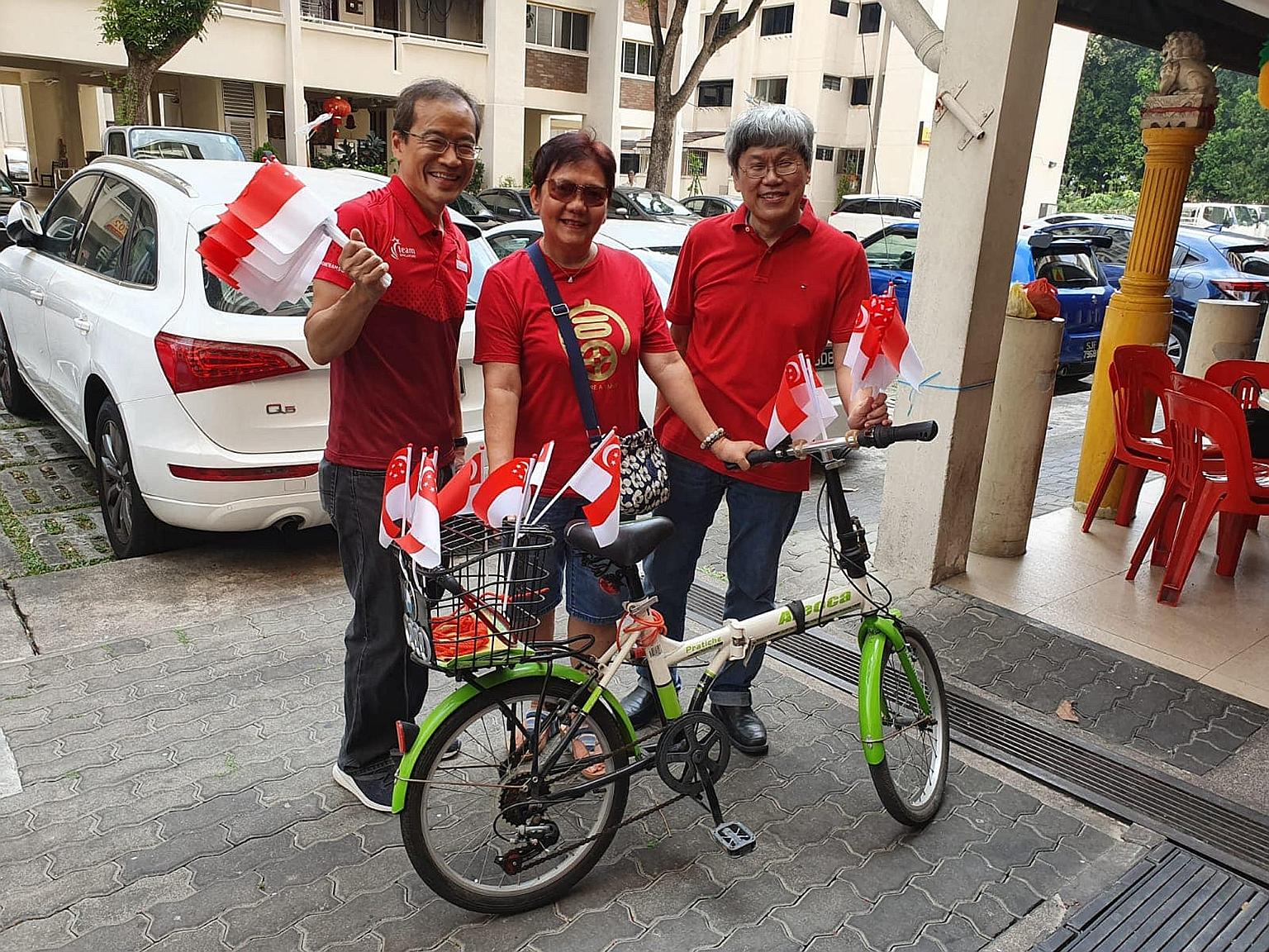 Workers' Party Non-Constituency MP Dennis Tan (left) and Hougang MP Png Eng Huat (right) with a resident last year. Mr Tan has been tipped to take over from Mr Png in the coming general election. PHOTO: DENNIS TAN/FACEBOOK