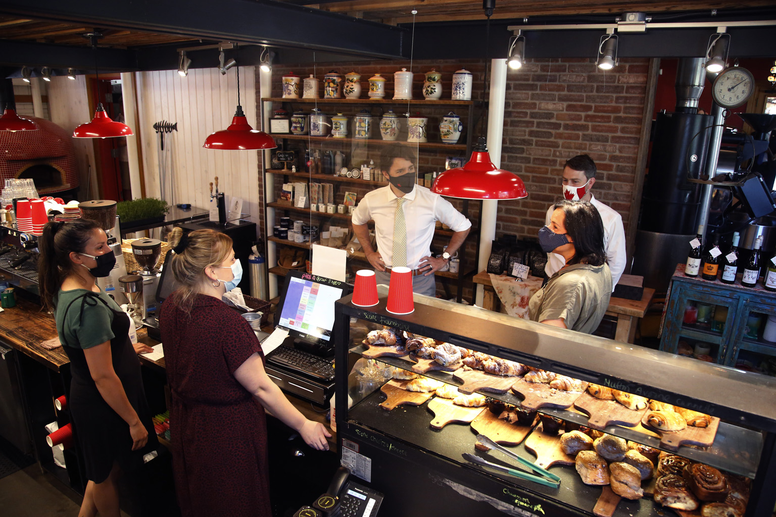 Canada's Prime Minister Justin Trudeau chatting with Ms Manuela Teixeira, the owner of a cafe in Quebec, during a visit last week with MP Will Amos. A poll by global PR firm Edelman covering 11 countries, including Canada, shows trust in governments