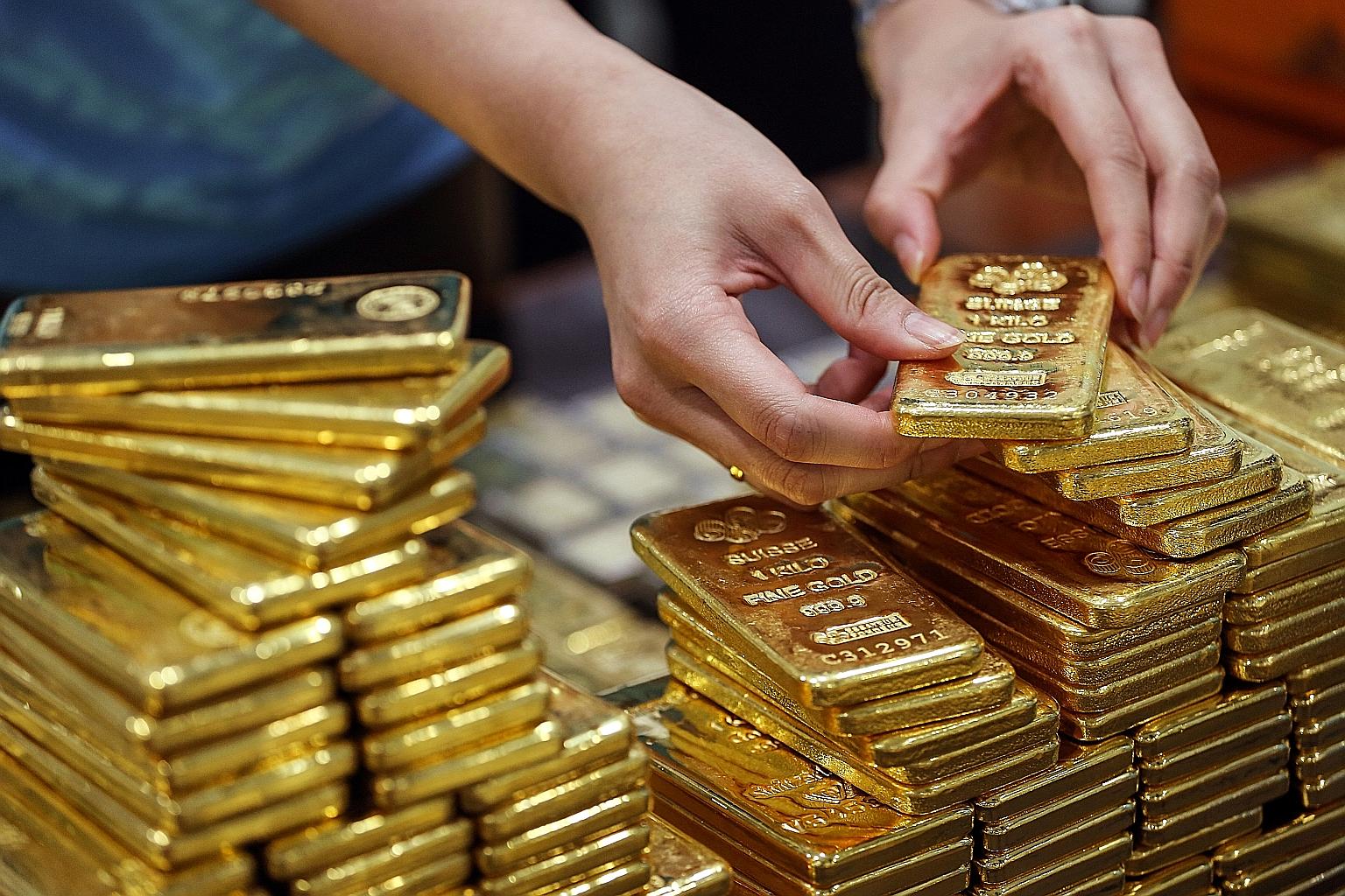 Gold is up 15 per cent this year, buoyed by unprecedented stimulus to aid the global economy, which has been hurt by the lockdowns due to the coronavirus pandemic. PHOTO: BLOOMBERG