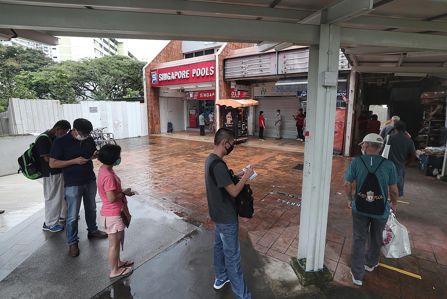 The outlet at Block 446 Clementi Avenue 3 saw a long queue of punters yesterday afternoon, the first day of Singapore Pools' reopening.