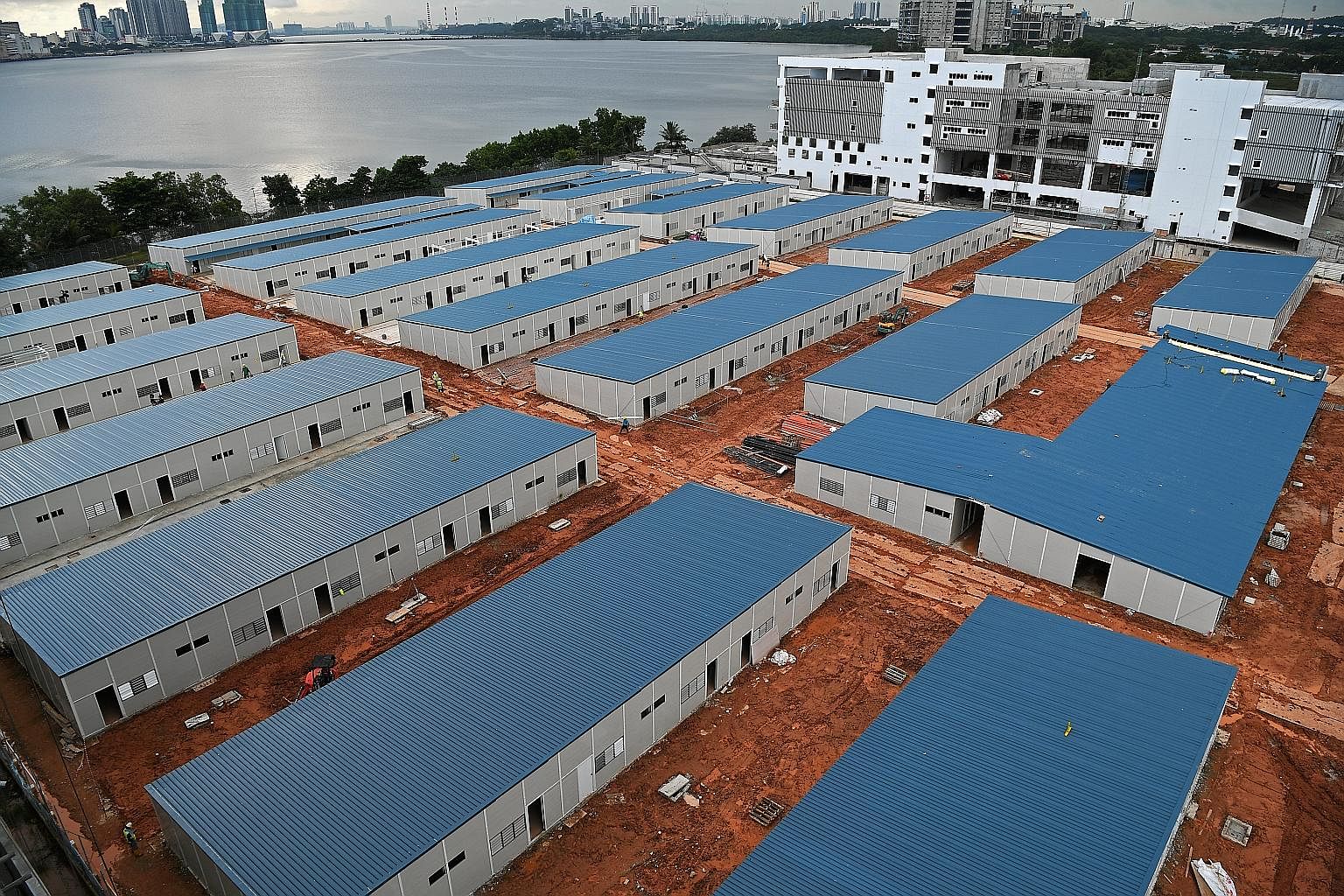 A new Quick Build Dormitory (QBD) is being built in Kranji Way. It is one of the temporary structures that will serve as a test bed for the Government to pilot improved standards for dormitories before it decides on specifications for new permanent d