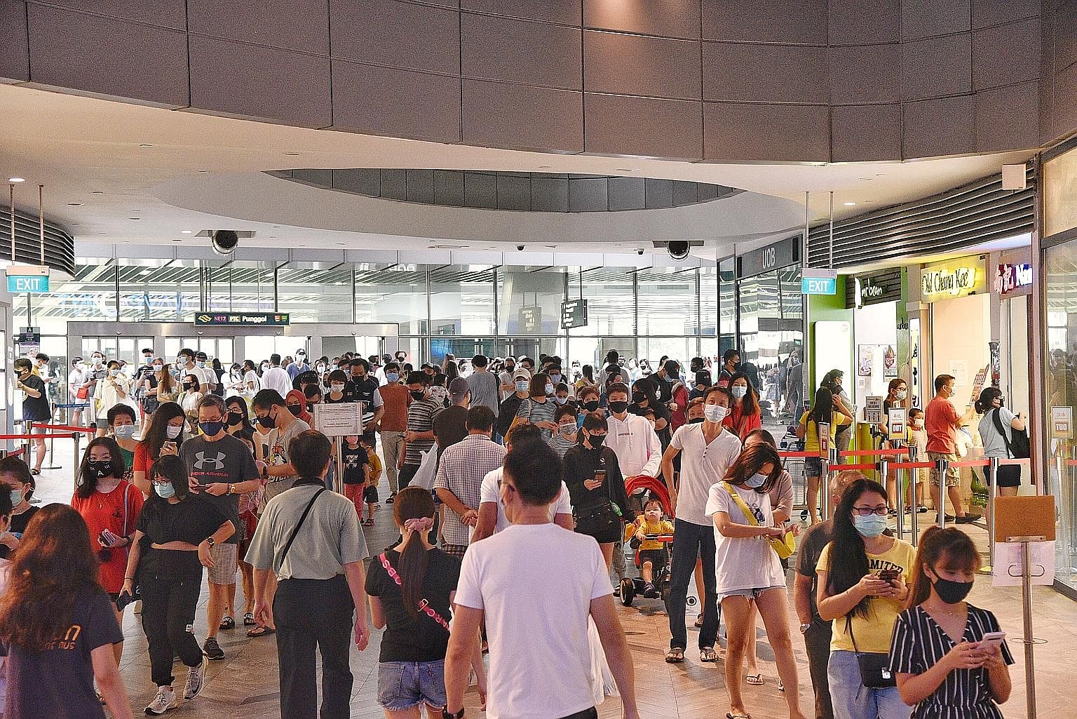 A large crowd of people waiting to enter Waterway Point in Punggol on Saturday. Experts have expressed concern over the way people have been going out and about. They still recommend staying at home, but well-ventilated and uncrowded places are a bet