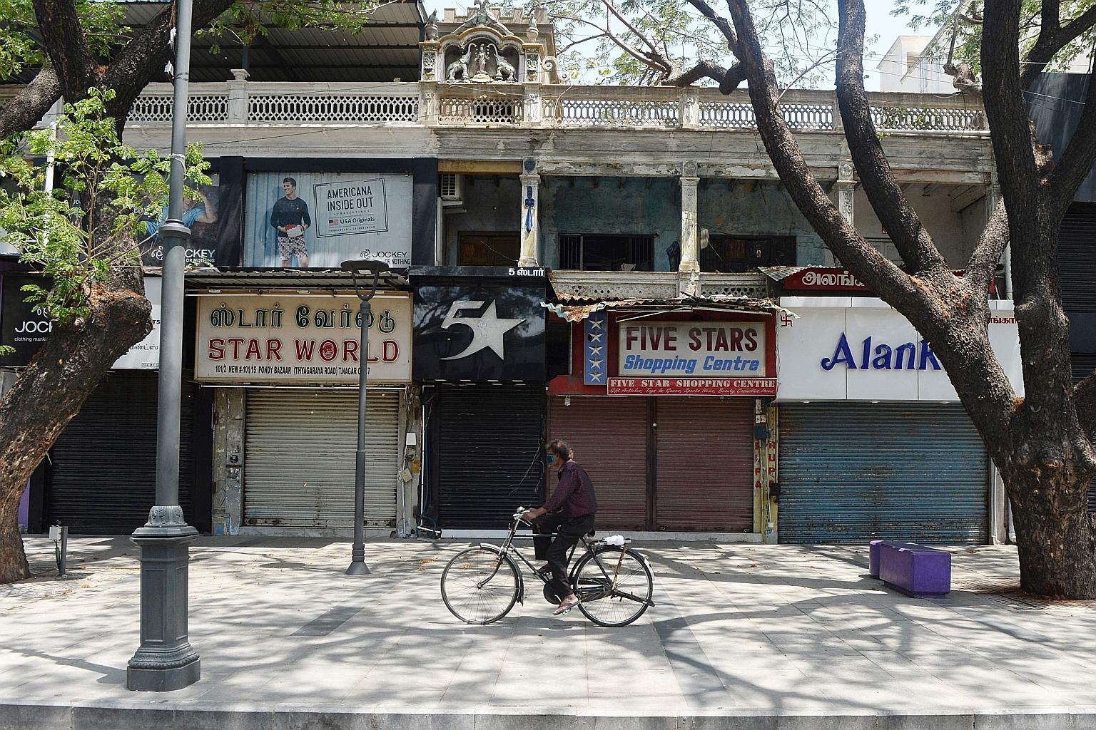 Closed shops in a commercial street in Chennai after a second lockdown was imposed last Friday to curb the spread of Covid-19. Only pharmacies and hospitals are allowed to operate. PHOTO: AGENCE FRANCE-PRESSE