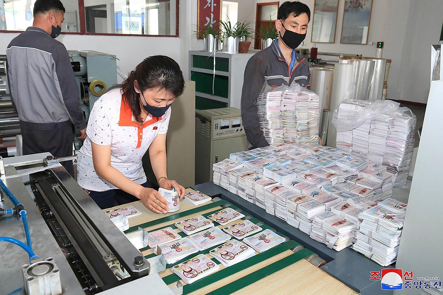A photo released by the Korean Central News Agency last Saturday showing North Koreans preparing anti-Seoul leaflets. The agency also said that more than "3,000 balloons of various types capable of scattering leaflets deep inside South Korea have bee
