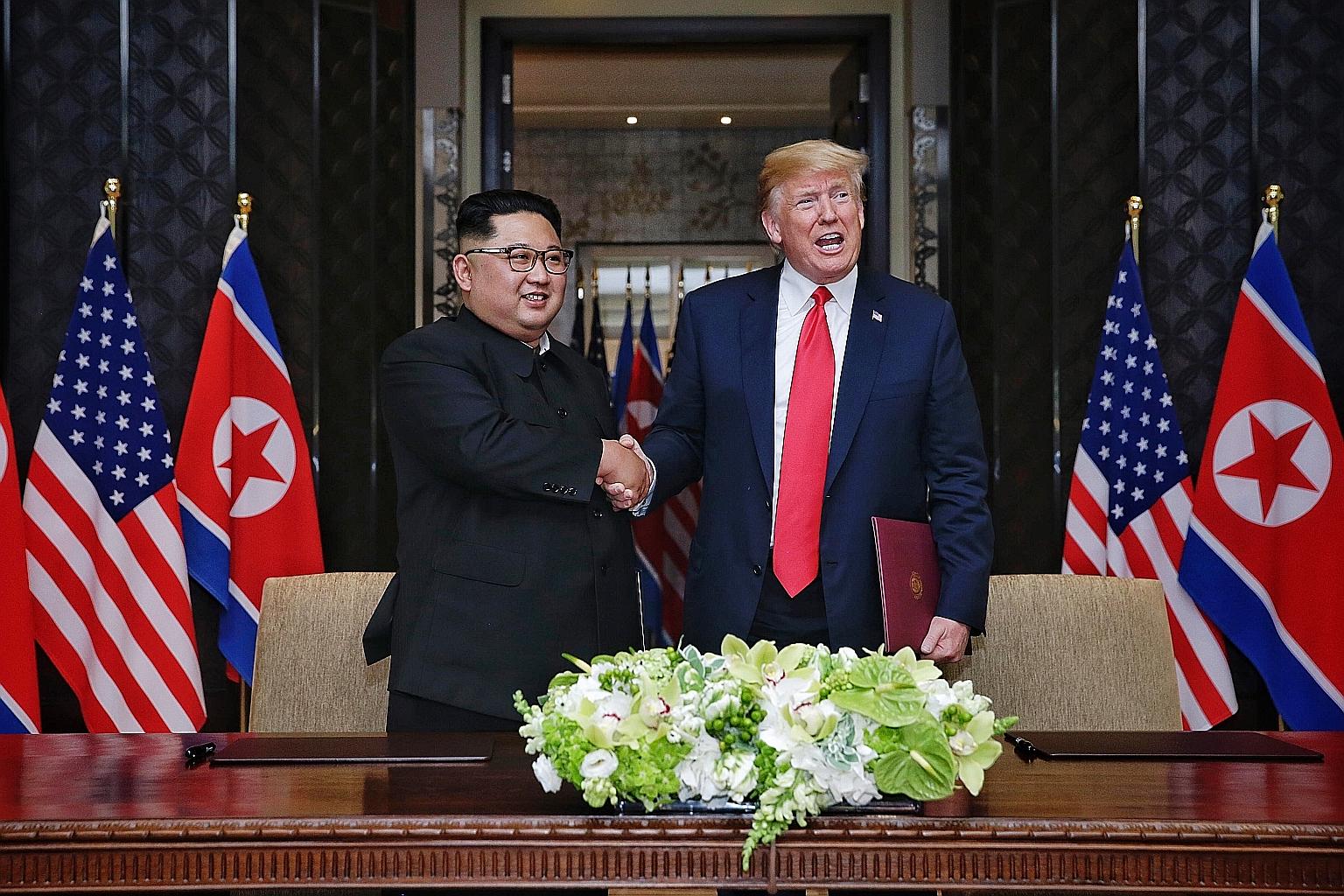 North Korean leader Kim Jong Un and US President Donald Trump at their historic 2018 summit in Singapore. Former US national security adviser John Bolton says Mr Kim had asked Mr Trump how he assessed him, and the President replied that he saw him as