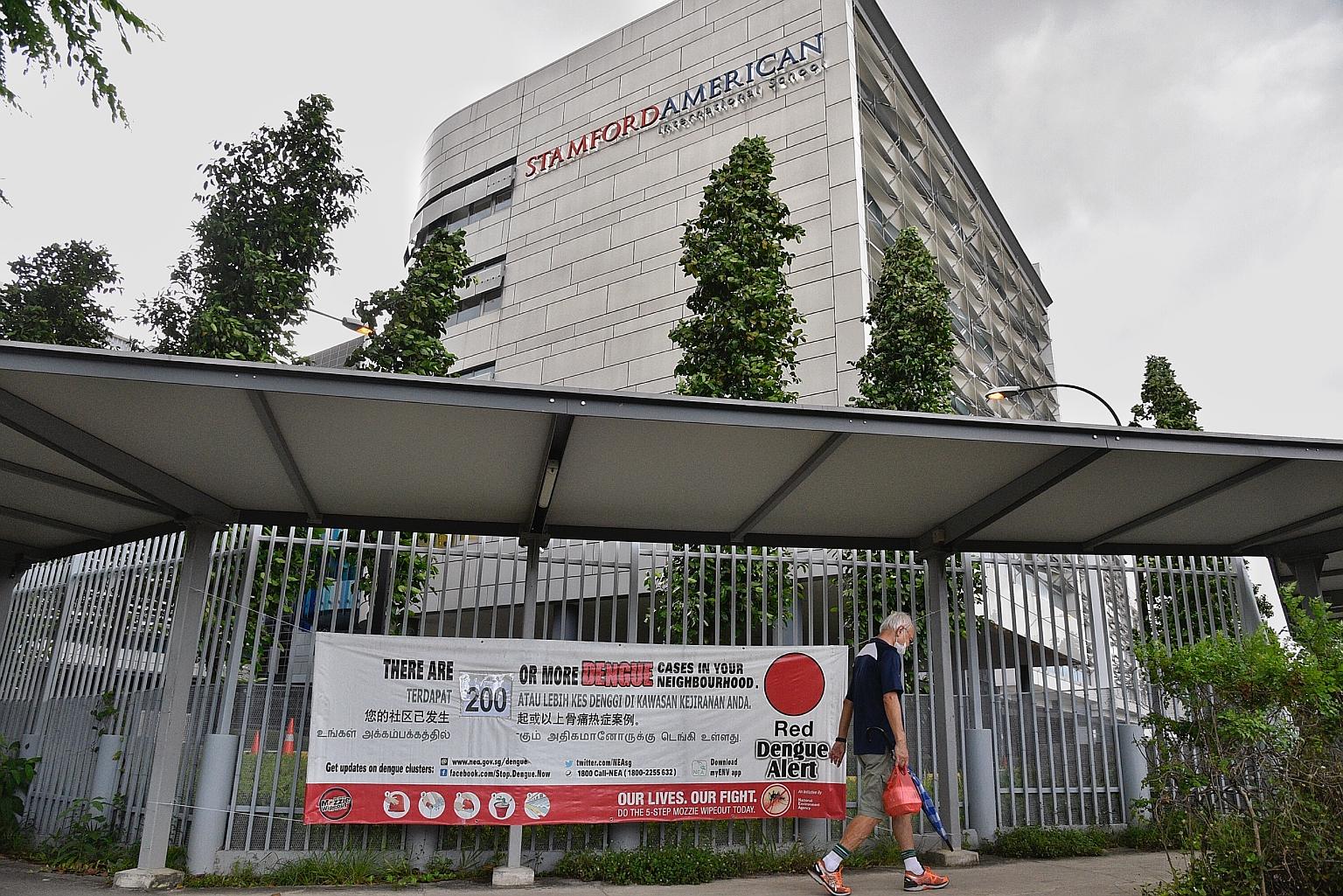 A red dengue alert banner outside the Stamford American International School in Woodleigh Lane on June 16. The Woodleigh area in Potong Pasir is the largest dengue cluster, with 212 infections.