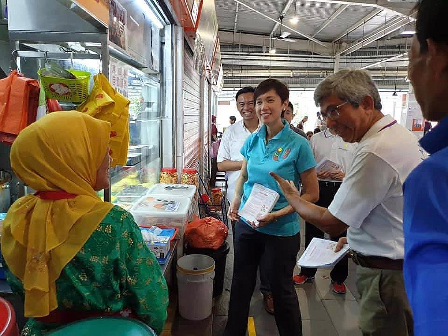 Dr Yaacob Ibrahim introducing Manpower Minister Josephine Teo and potential candidate and polytechnic senior lecturer Wan Rizal Wan Zakariah - both expected to contest in Jalan Besar GRC - to residents at a Geylang Bahru market in Kolam Ayer ward of