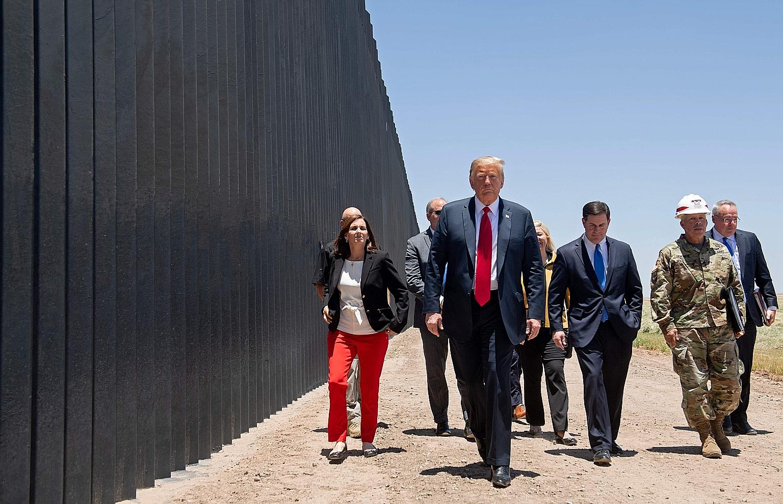 Prior to his campaign appearance in Phoenix, Arizona, on Tuesday, United States President Donald Trump also visited a newly built section of the border wall along the frontier with Mexico where he autographed a plaque commemorating the 200th mile of 