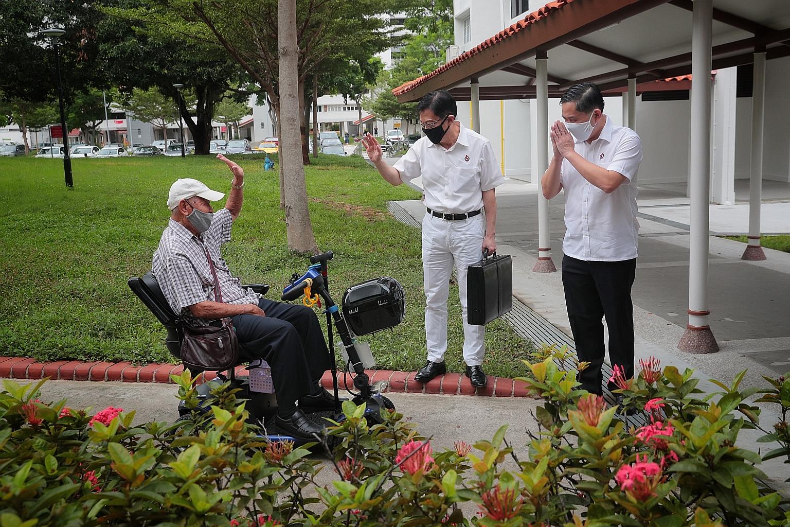 Deputy Prime Minister Heng Swee Keat (centre) and PAP headquarters executive director Alex Yam greeting a resident as they arrived at the party HQ in New Upper Changi Road yesterday for a session to introduce new candidates. ST PHOTO: JASON QUAH