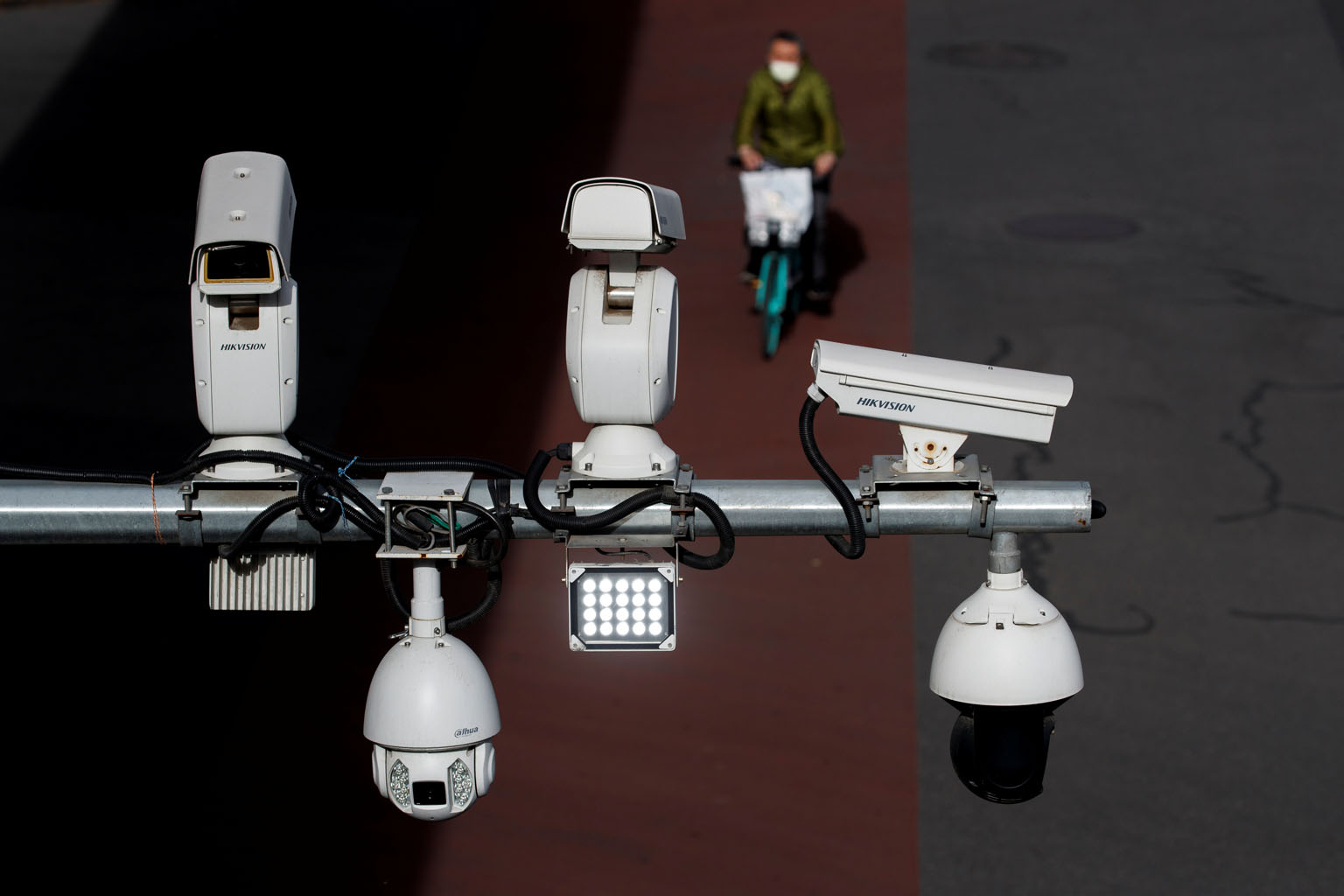 Hikvision and Dahua's closed-circuit television security surveillance cameras over a street in Beijing. Hikvision has been named by the US as one of the companies that are owned or controlled by the Chinese military. PHOTO: REUTERS