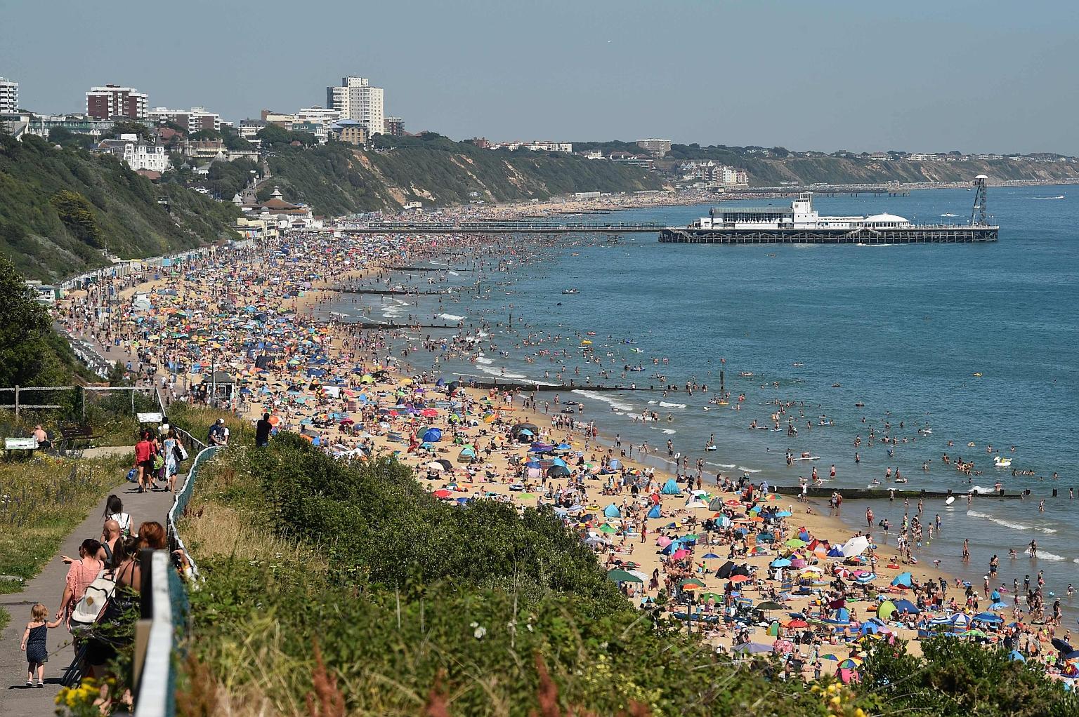 Beachgoers in Bournemouth on Thursday. With beaches packed, Britain's chief medical officer warned of the risk of infection.