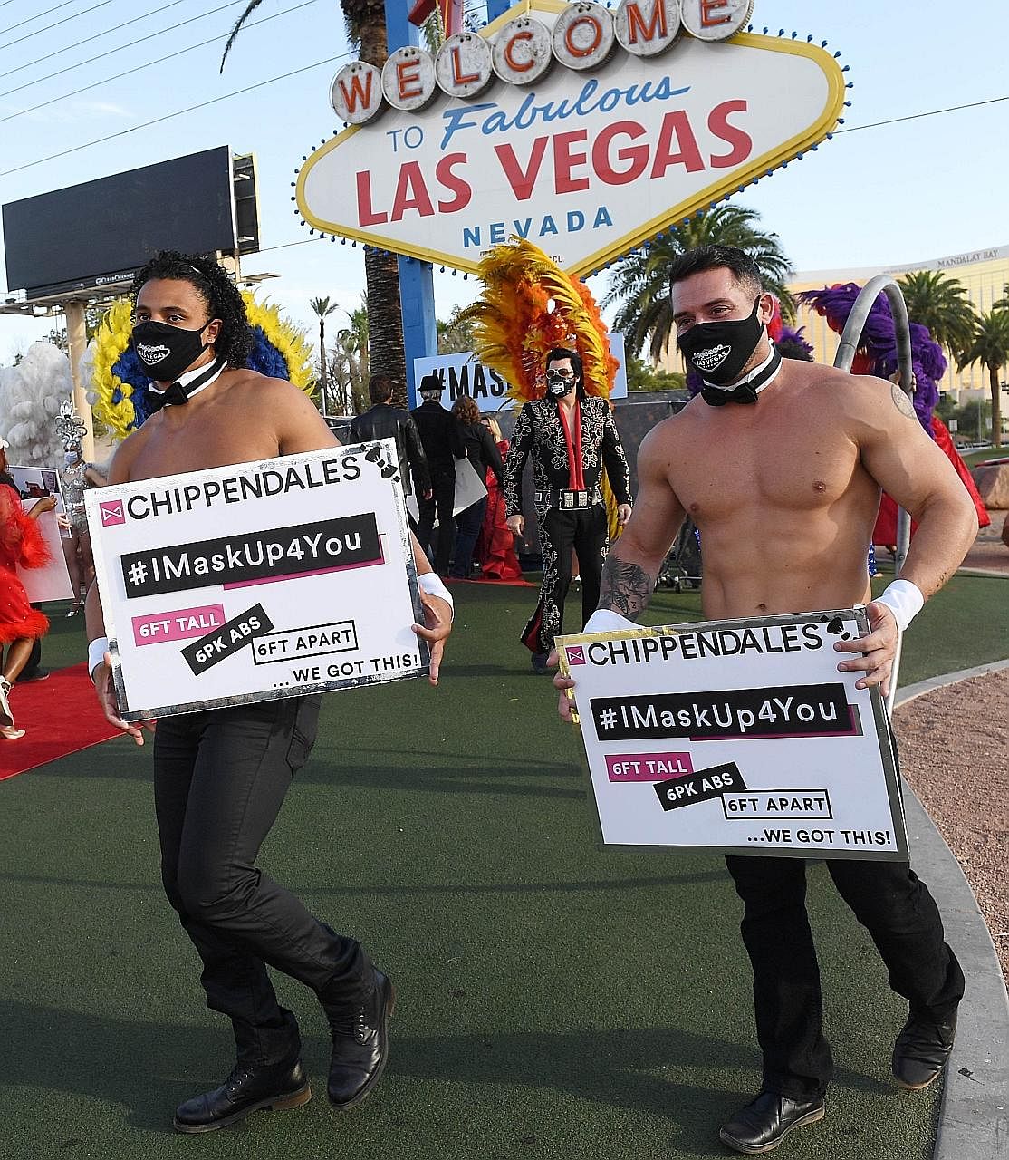 Las Vegas entertainers kicking off a pro-mask wearing campaign at a fashion show in Nevada's gambling hub on Thursday. PHOTO: AGENCE FRANCE-PRESSE