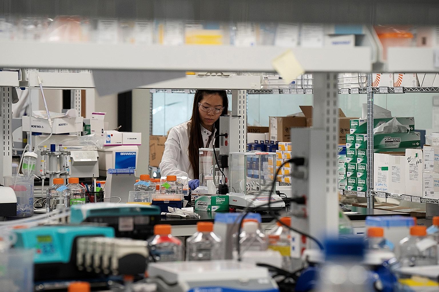 A research associate from Arcturus Therapeutics working on a coronavirus vaccine in San Diego, California, in March. The team from Duke-NUS Medical School plans to start clinical trials for the mRNA vaccine that it is working on jointly with Arcturus