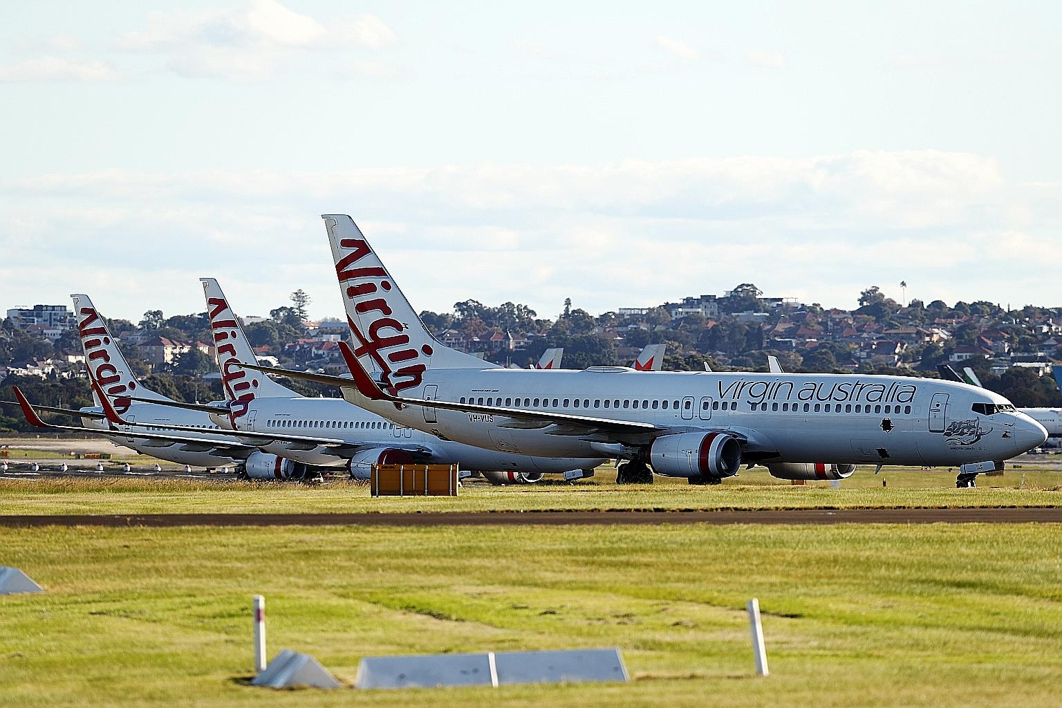Virgin Australia planes on the tarmac at Sydney Airport yesterday. Bain said it will strengthen the carrier's regional services and continue serving business travellers, but the deal may face a further challenge from Virgin Australia's bond holders, who t