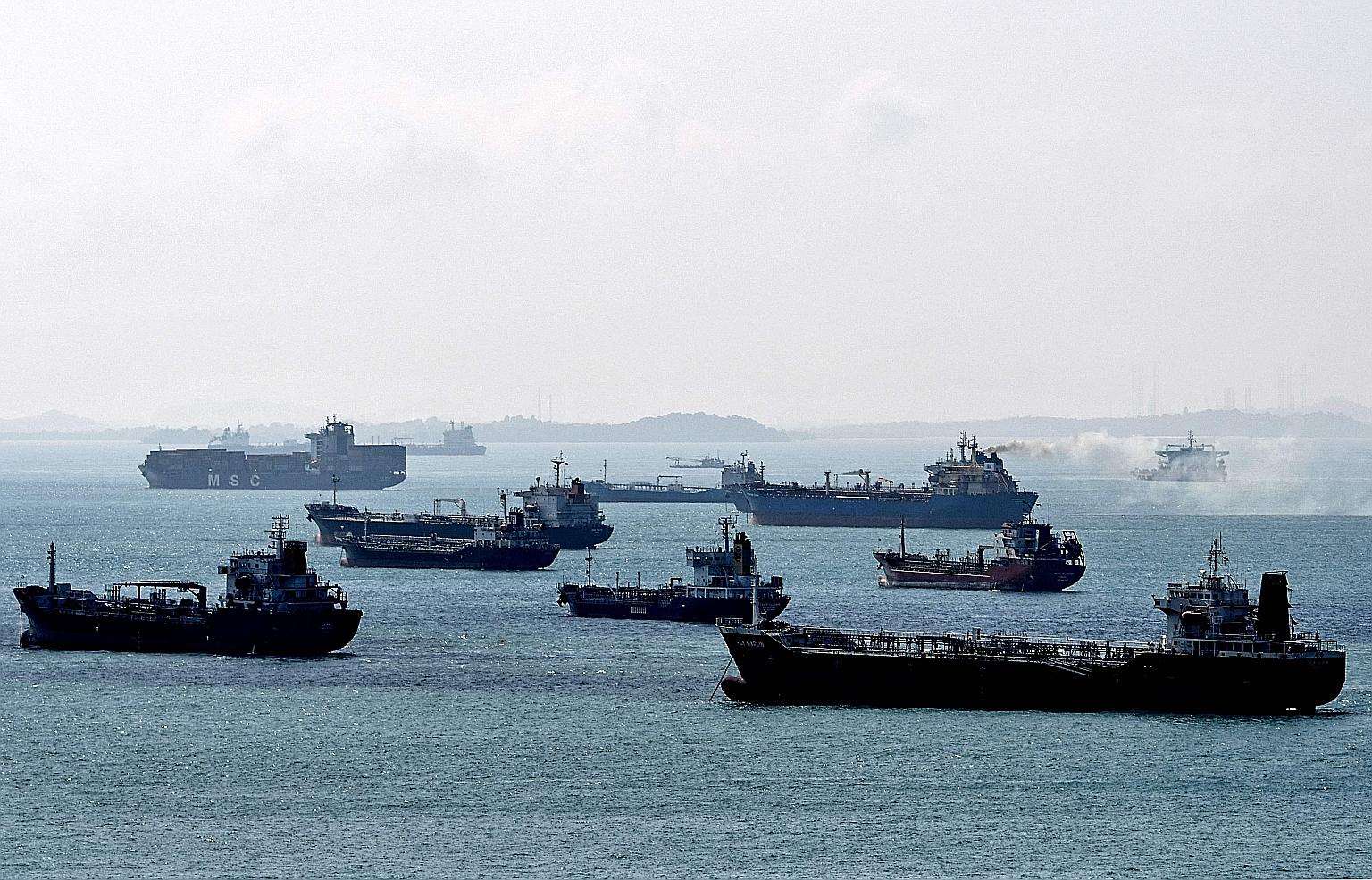 Oil tankers seen anchored off the western shores of Singapore in February 2018. Some 82.5 million barrels of crude and oil products were sitting in 67 vessels parked off Singapore and in the Malacca Strait as of Tuesday, according to data intelligence fir