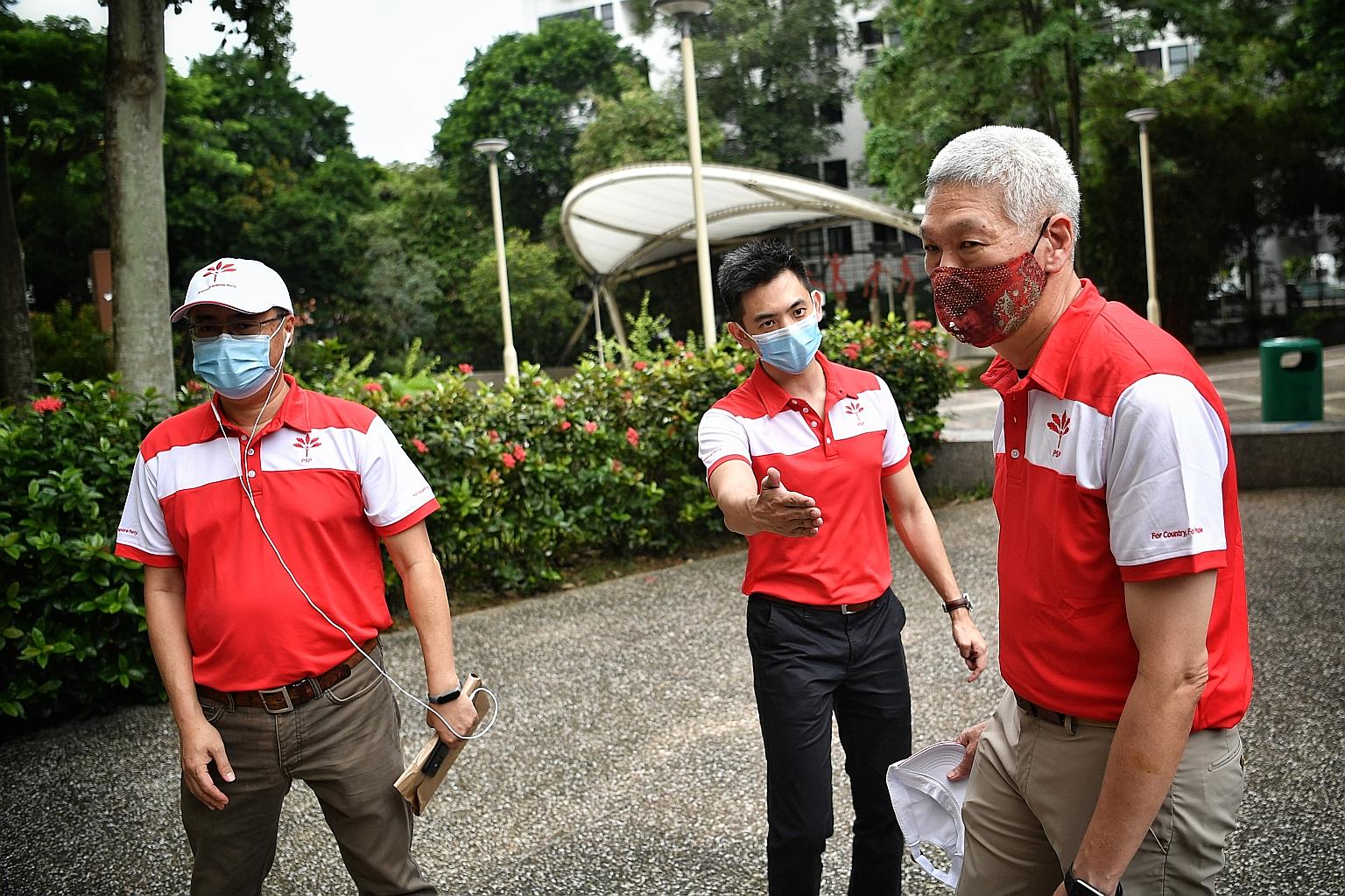 (From left) PSP members Michael Chua, Terence Soon and Lee Hsien Yang on their walkabout in Holland Close yesterday. Mr Lee, Prime Minister Lee Hsien Loong's brother, did not say if he would contest the election.