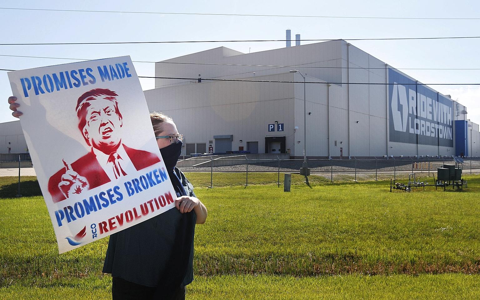 A protester calling for US President Donald Trump's election promises to be fulfilled, outside Lordstown Motors Corp in Warren, Ohio, on Thursday. US Vice-President Mike Pence was visiting the city to speak at the unveiling of a new all-electric pick