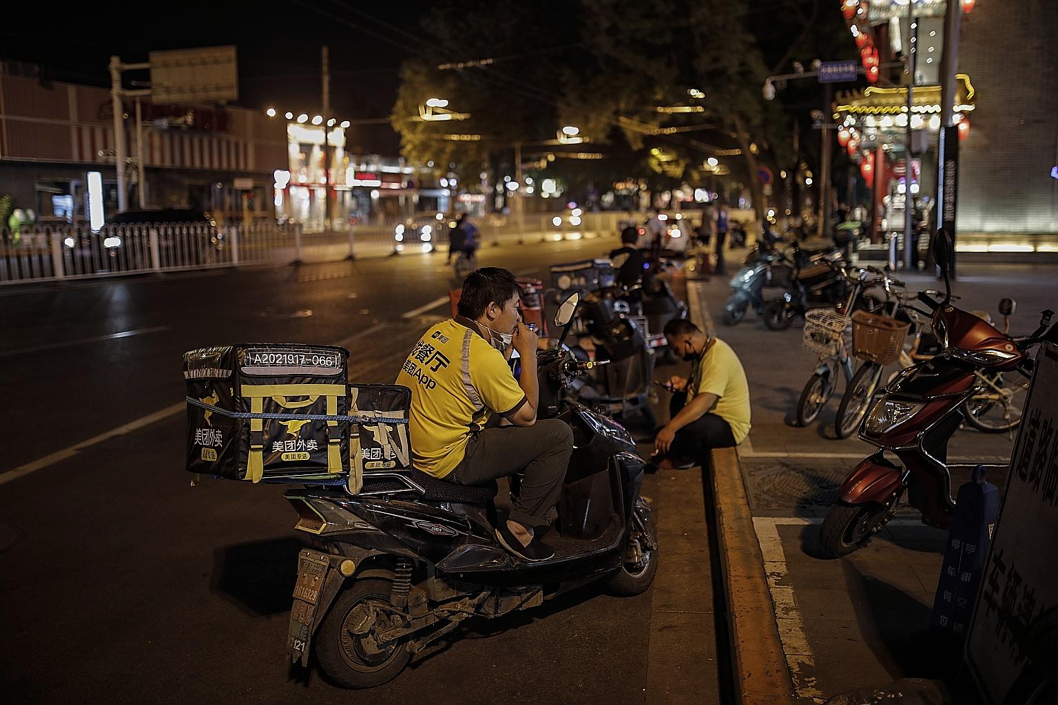 Beijing has ordered 100,000 delivery riders - including those who deliver food and groceries and others who handle online shopping - to undergo nucleic acid testing for the coronavirus. PHOTO: EPA-EFE
