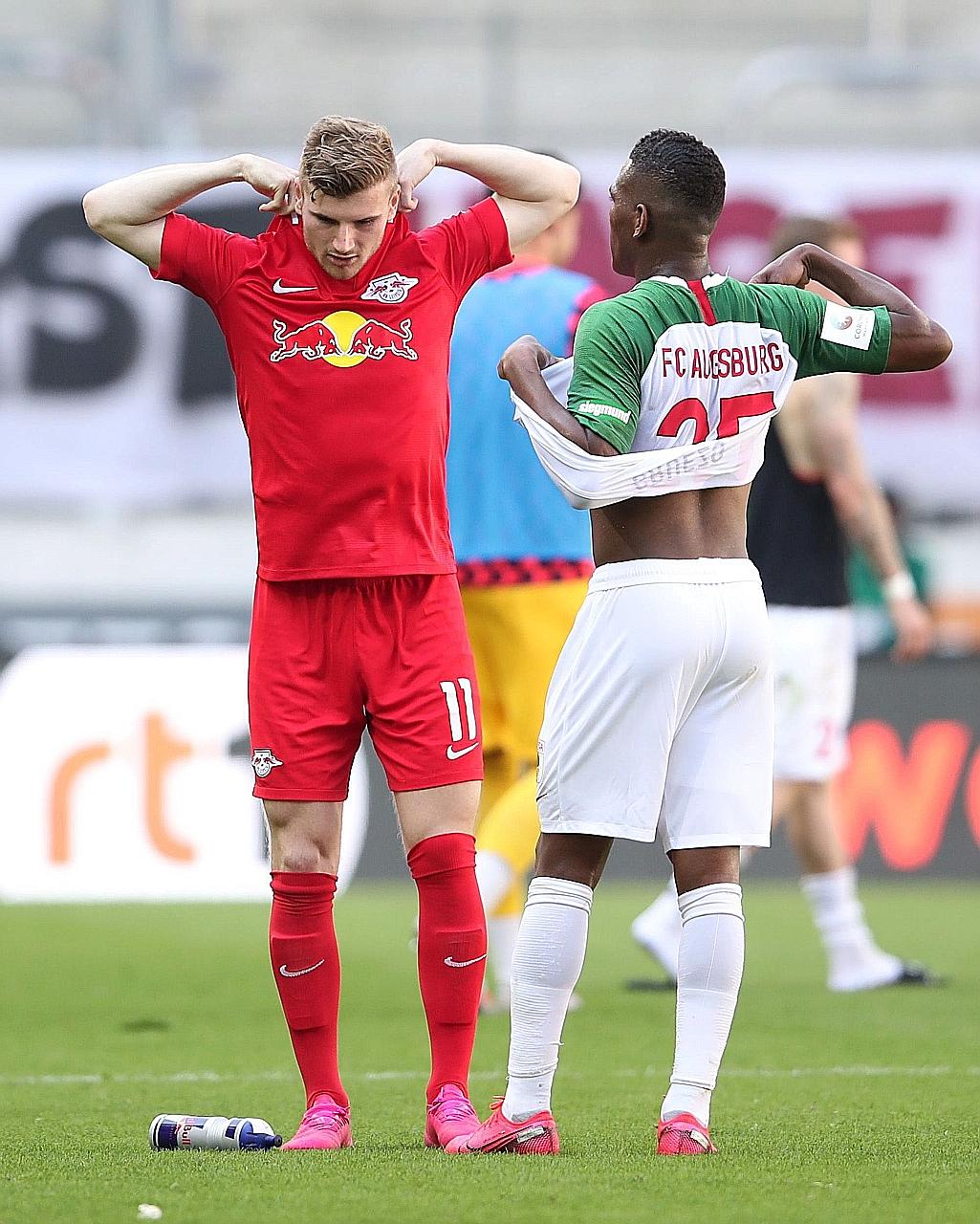 Leipzig's Timo Werner swopping shirts with Augsburg's Ecuadorian midfielder Carlos Gruezo after their Bundesliga game on Saturday. The German is moving to Chelsea.