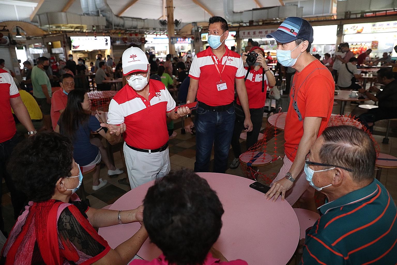Progress Singapore Party chief Tan Cheng Bock (in white cap) visiting Boon Lay Place Market and Food Village yesterday. Dr Tan said that he was responsible for a lot of the development in the constituency when he was the People's Action Party MP for 