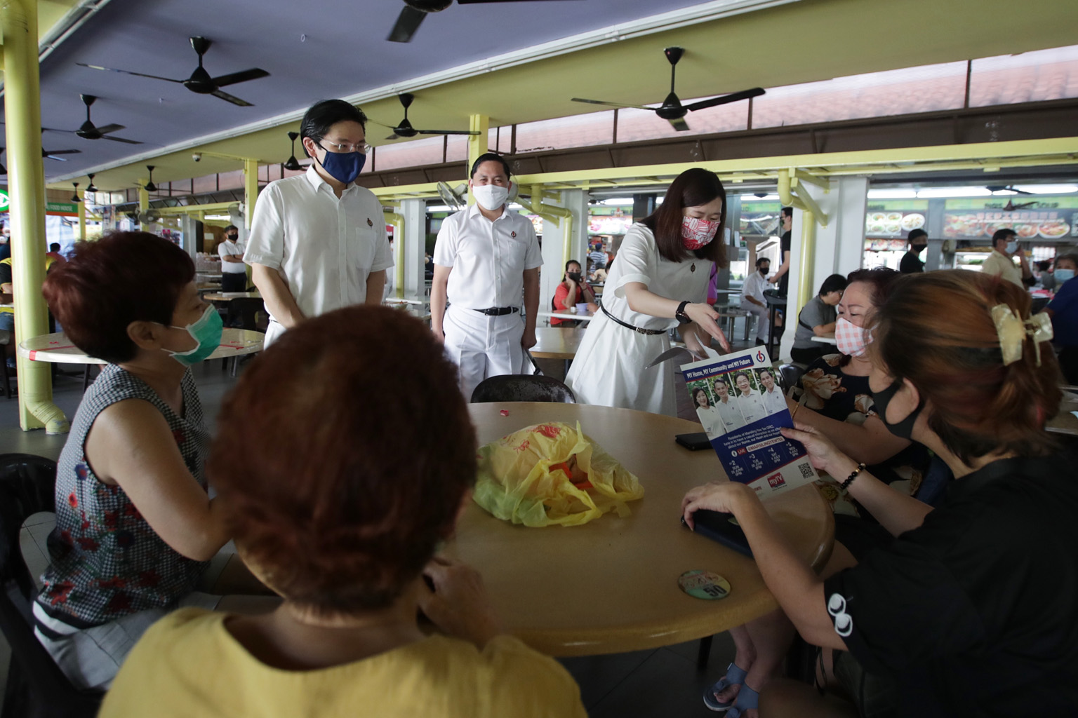 PAP new face Hany Soh, together with National Development Minister Lawrence Wong and Mr Alex Yam (centre), talking to residents in Woodlands Street 31 yesterday. The fourth member of the PAP's team in Marsiling-Yew Tee GRC is Minister of State for Na