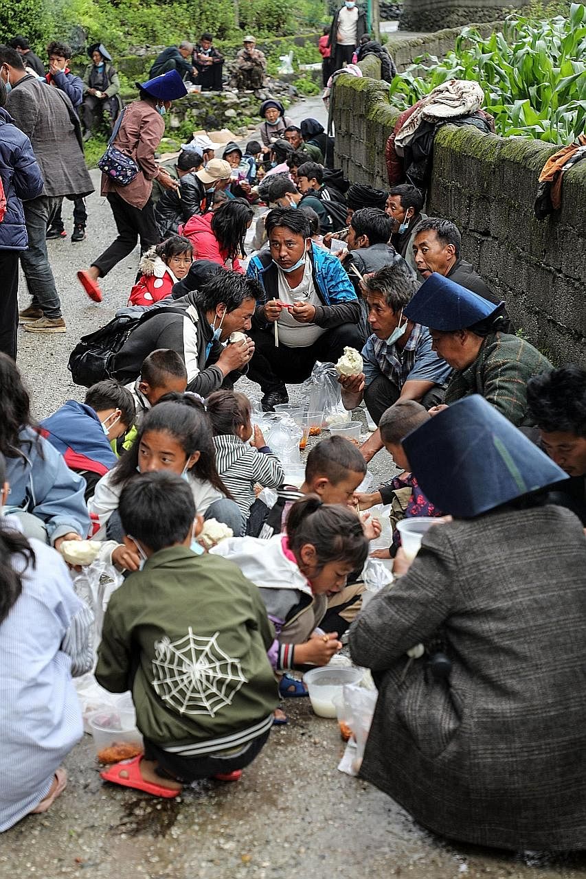 People affected by floods having breakfast at a temporary shelter in Mianning county, in the Liangshan Yi Autonomous Prefecture of south-western Sichuan province yesterday. Much of the damage has hit south-western regions of China such as Guangxi and