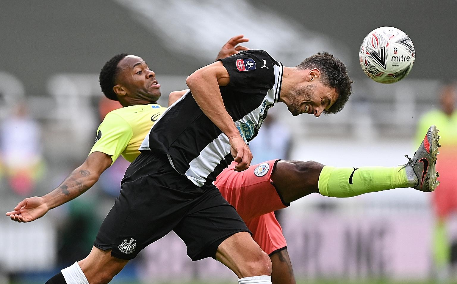 Newcastle centre-back Fabian Schar (front) defending against Manchester City striker Raheem Sterling during their FA Cup quarter-final at St James' Park on Sunday. Sterling and Kevin de Bruyne were on target in the 2-0 win which earned City a semi-fi