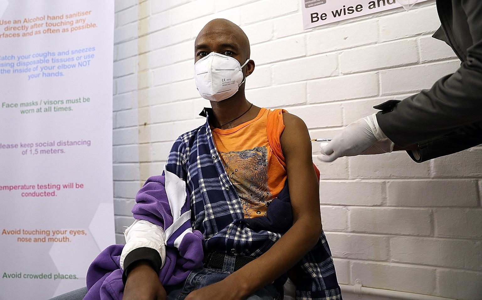 A man getting an injection during a clinical trial for a potential Covid-19 vaccine at the Baragwanath hospital in Soweto, South Africa, on June 24. The world faces problems of how to produce enough vaccines to meet global demand, and how to ensure i