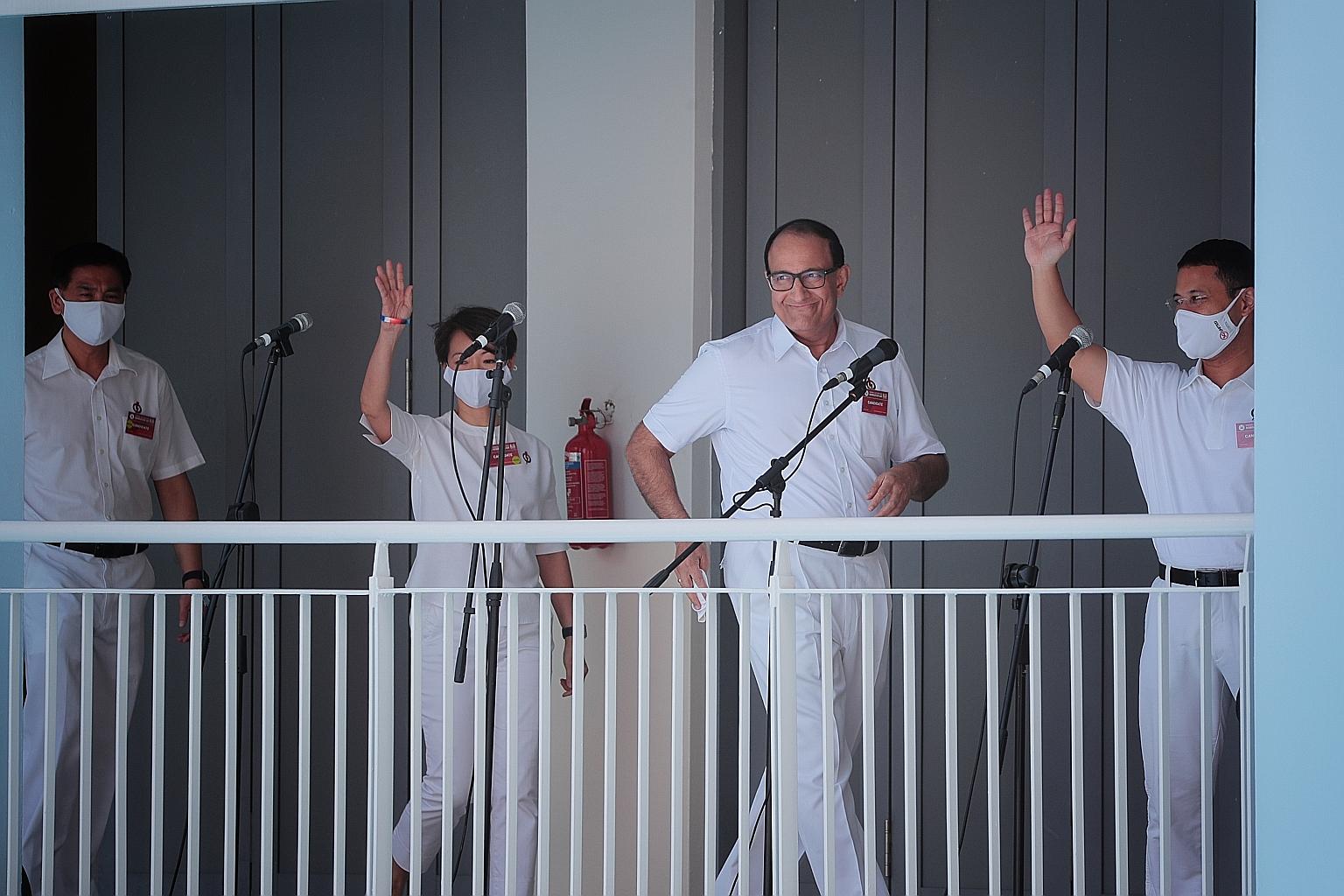 PAP candidates for West Coast GRC (from left) Ang Wei Neng, Foo Mee Har and S. Iswaran at Nan Hua High School yesterday. ST PHOTO: JASON QUAH