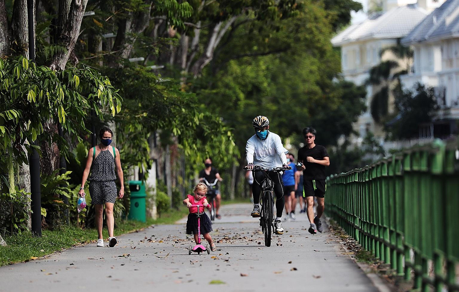 A cyclist breezing through the path of the Ulu Pandan Park Connector while sharing it with a girl on her kick scooter in May, while Singapore was in the circuit breaker to halt the transmission of the coronavirus.