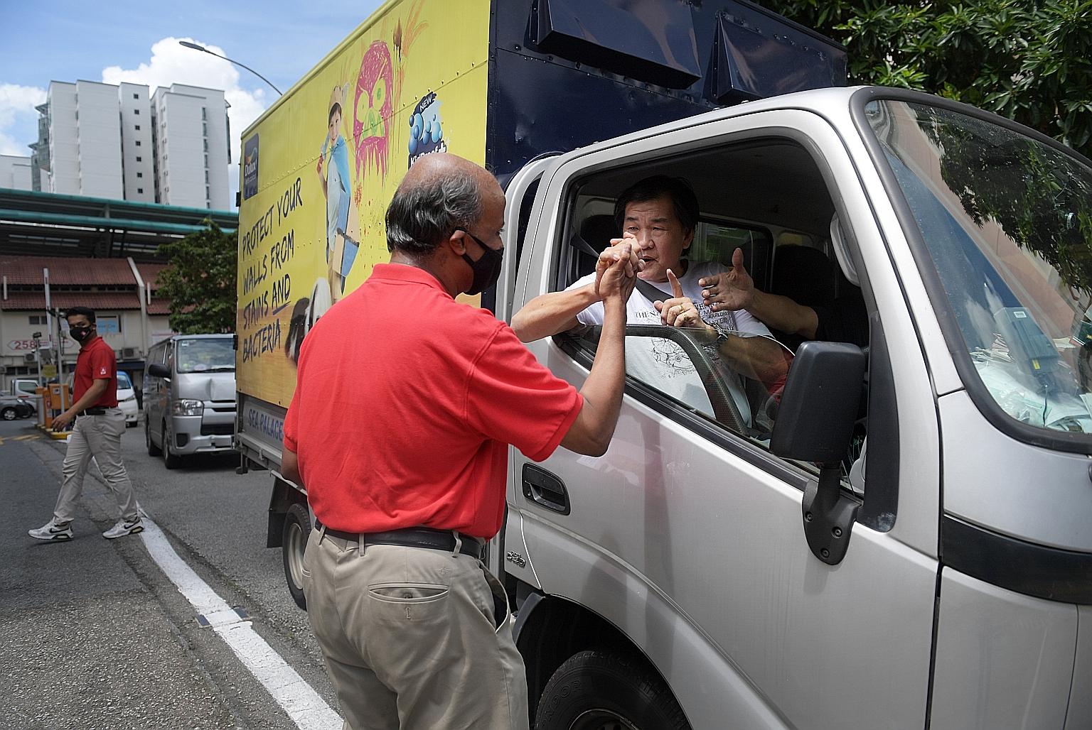 Singapore Democratic Party candidate Paul Tambyah meeting people in Bukit Panjang yesterday. He says he is keen to speak on behalf of residents there as the area brings back memories of his childhood days.