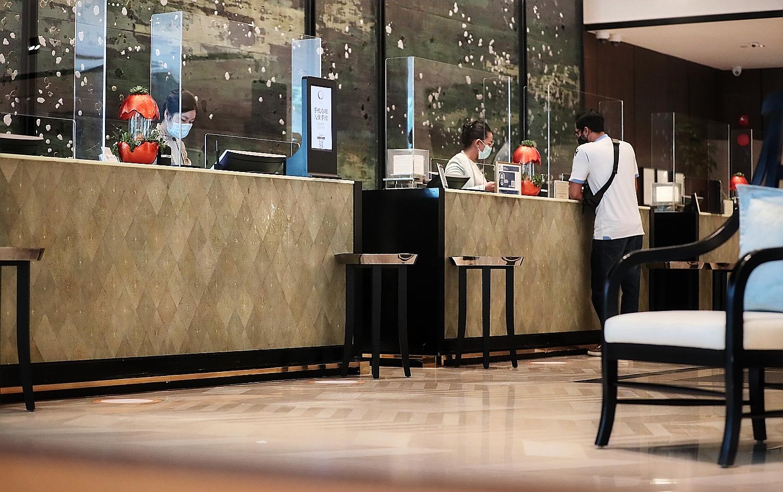 The Shangri-La Hotel's reception counters, fitted with plastic shields to minimise contact as part of safe management measures against Covid-19. The Singapore Tourism Board said hotels must implement measures such as staggering the check-in and check