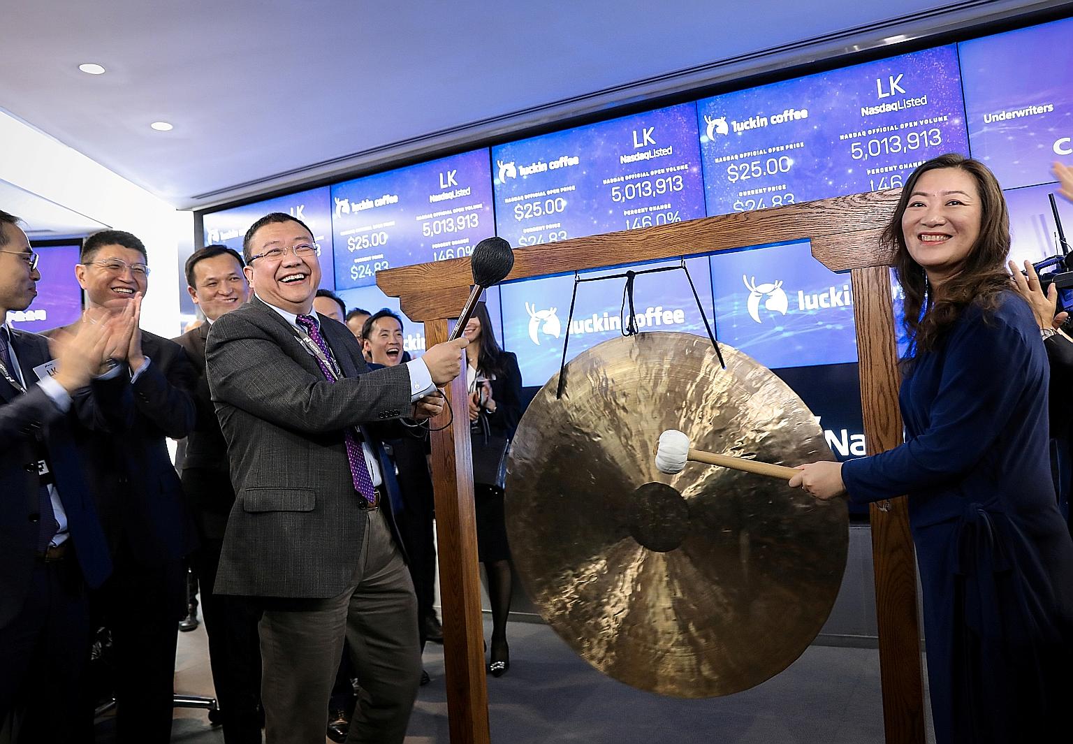 Luckin Coffee's chairman Charles Lu Zhengyao and then chief executive Jenny Qian Zhiya celebrating the company's initial public offering at the Nasdaq MarketSite in New York in May last year. 