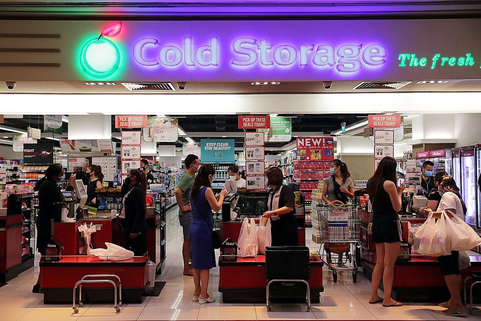 Customers at the checkout section of a supermarket. Singapore's goods and services thttp://staff.straitstimes.com/node/706106/edit?content_lock_token=KPrL2IMW04fAERmwThxSlJF5M5Pa2vax is set to be raised from 7 per cent to 9 per cent between 2022 and 2025.