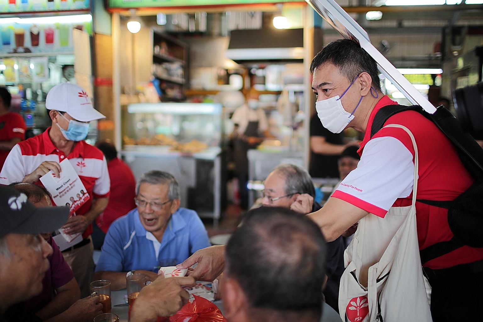 Progress Singapore Party members out to woo voters yesterday around Ayer Rajah Food Centre. The party is contesting West Coast GRC.