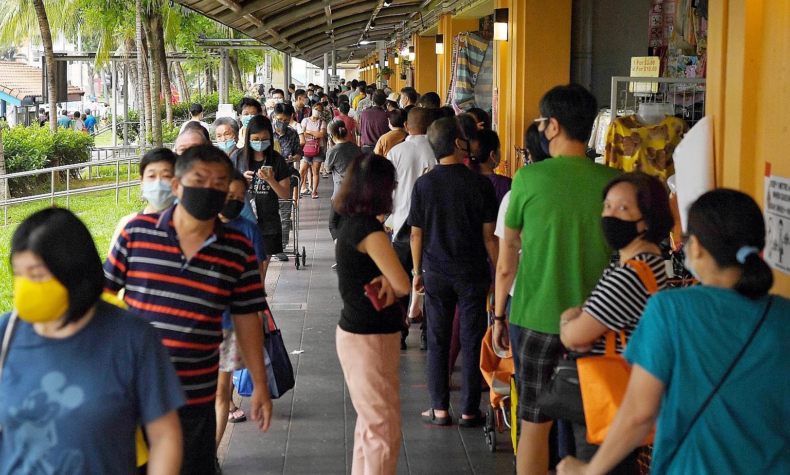 People queueing to enter a market in Hougang last Saturday. Right from the beginning of the crisis, the Government has systematically paid attention to the more vulnerable groups to look after them, says Prime Minister Lee Hsien Loong. ST PHOTO: KUA 