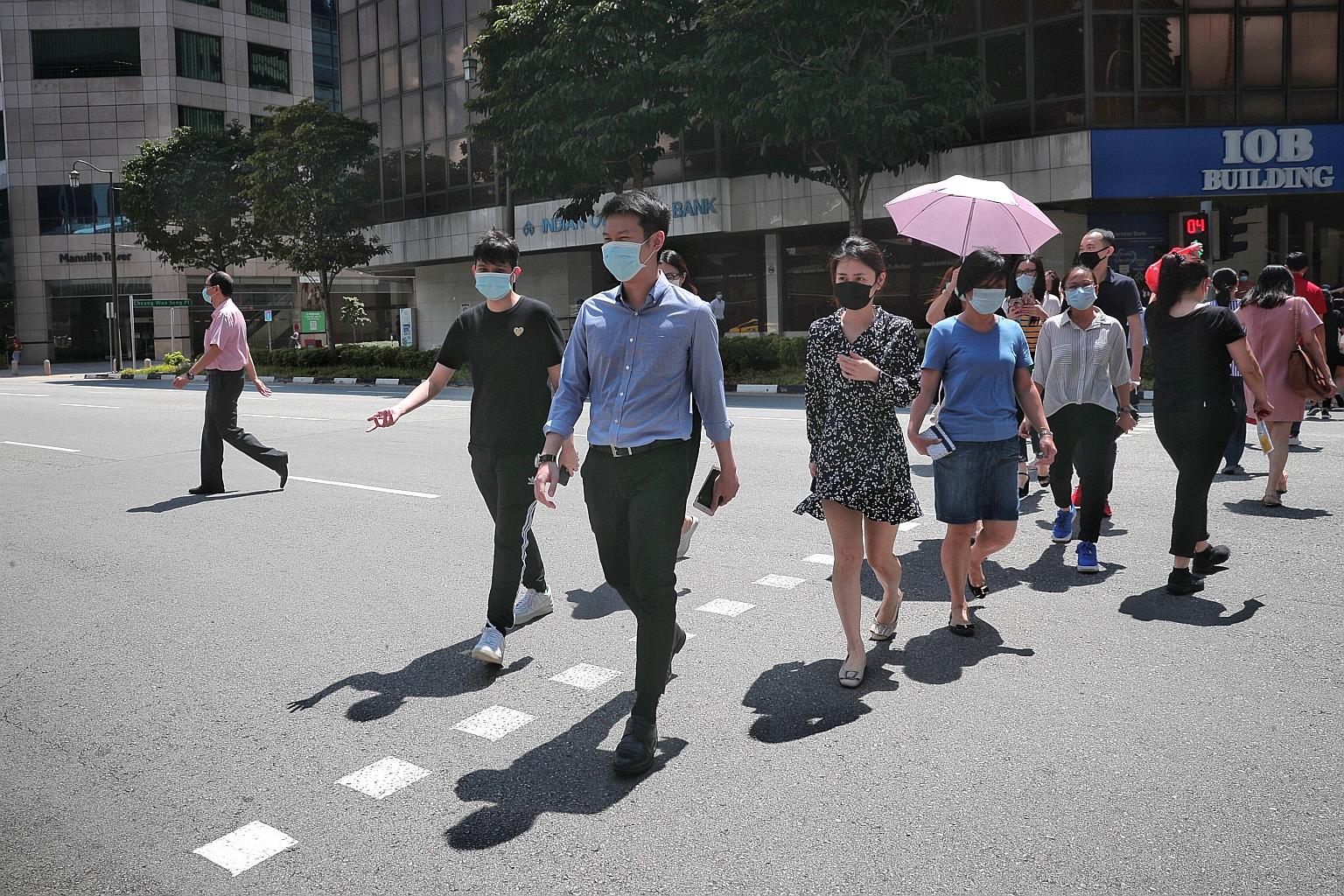 The lunchtime crowd at Cross Street during phase one last month. Amid the challenges posed by the pandemic, Mr Tharman Shanmugaratnam says the aim is to help all workers constantly improve their skills and income.
