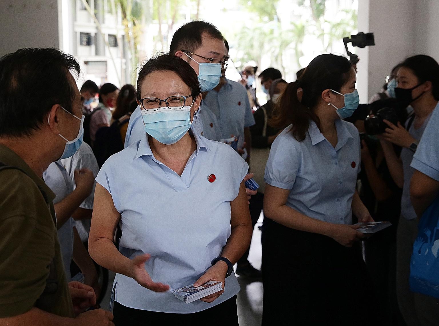 Workers' Party chairman Sylvia Lim (foreground) on a walkabout with members of the Sengkang GRC team, including Mr Louis Chua (behind her) and Ms He Ting Ru (right), at Rivervale Plaza yesterday.