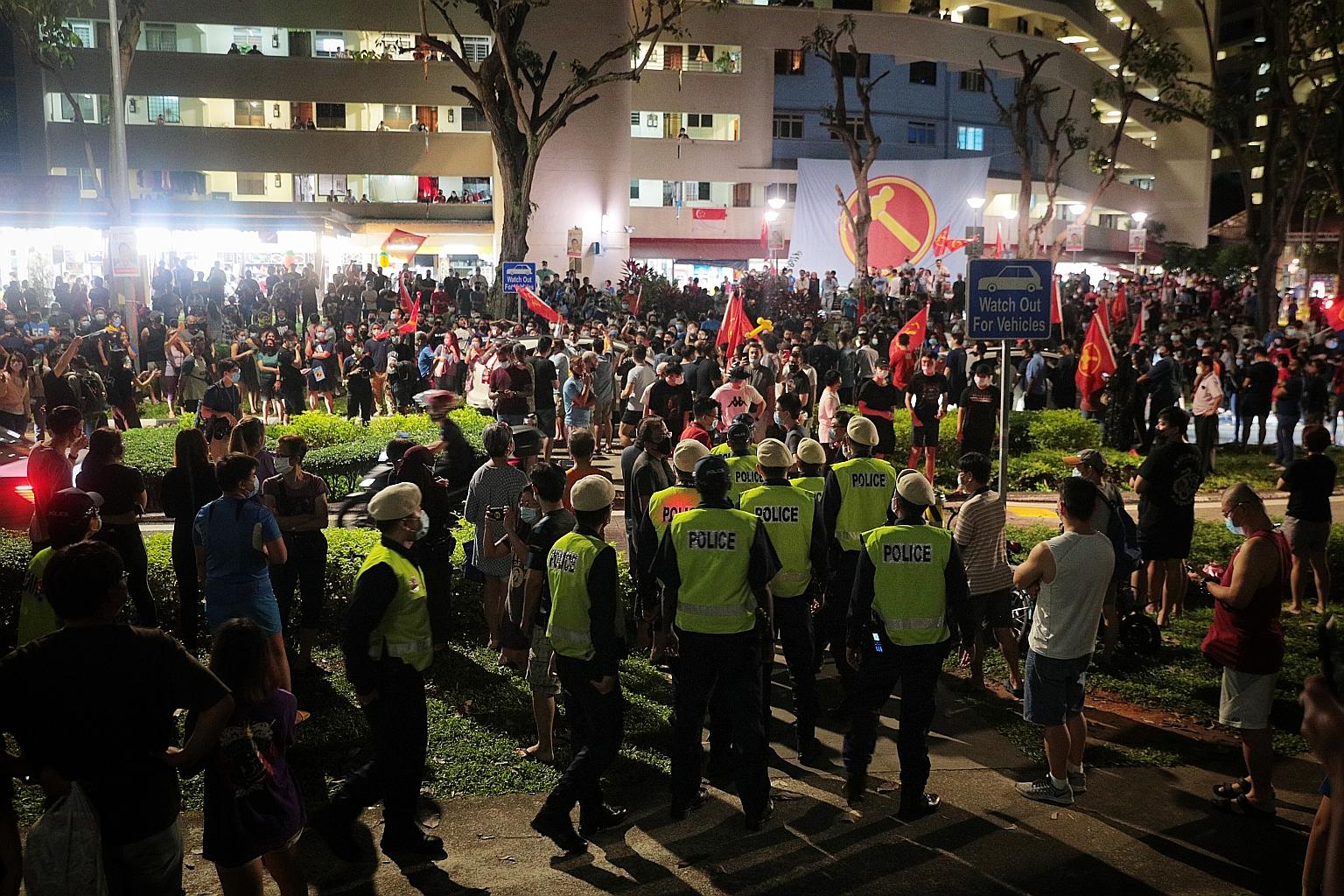Workers' Party supporters celebrating their Hougang win at Block 322 Hougang Avenue 5 earlier this morning. Shipping lawyer Dennis Tan, 49, retained the seat for his party with 61.19 per cent of the votes. ST PHOTO: JASON QUAH