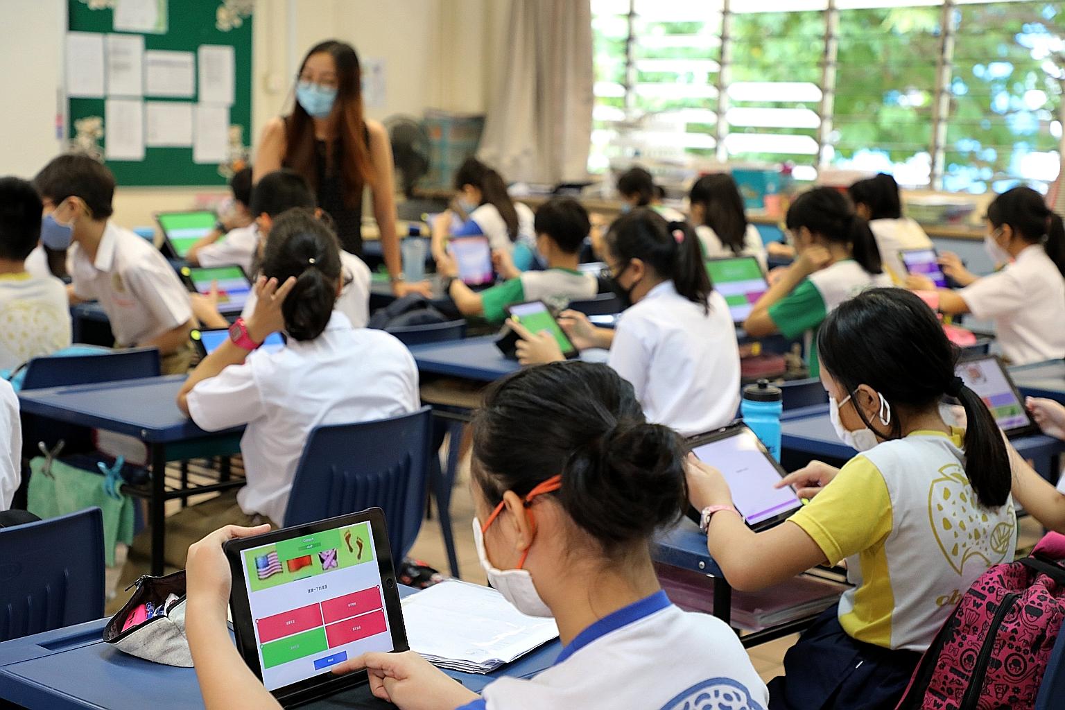 Qihua Primary School pupils preparing for the National Chinese Challenge by creating their own sets of questions and practising them in school last Thursday. A total of 104 primary schools registered their pupils for the contest. Secondary school stu