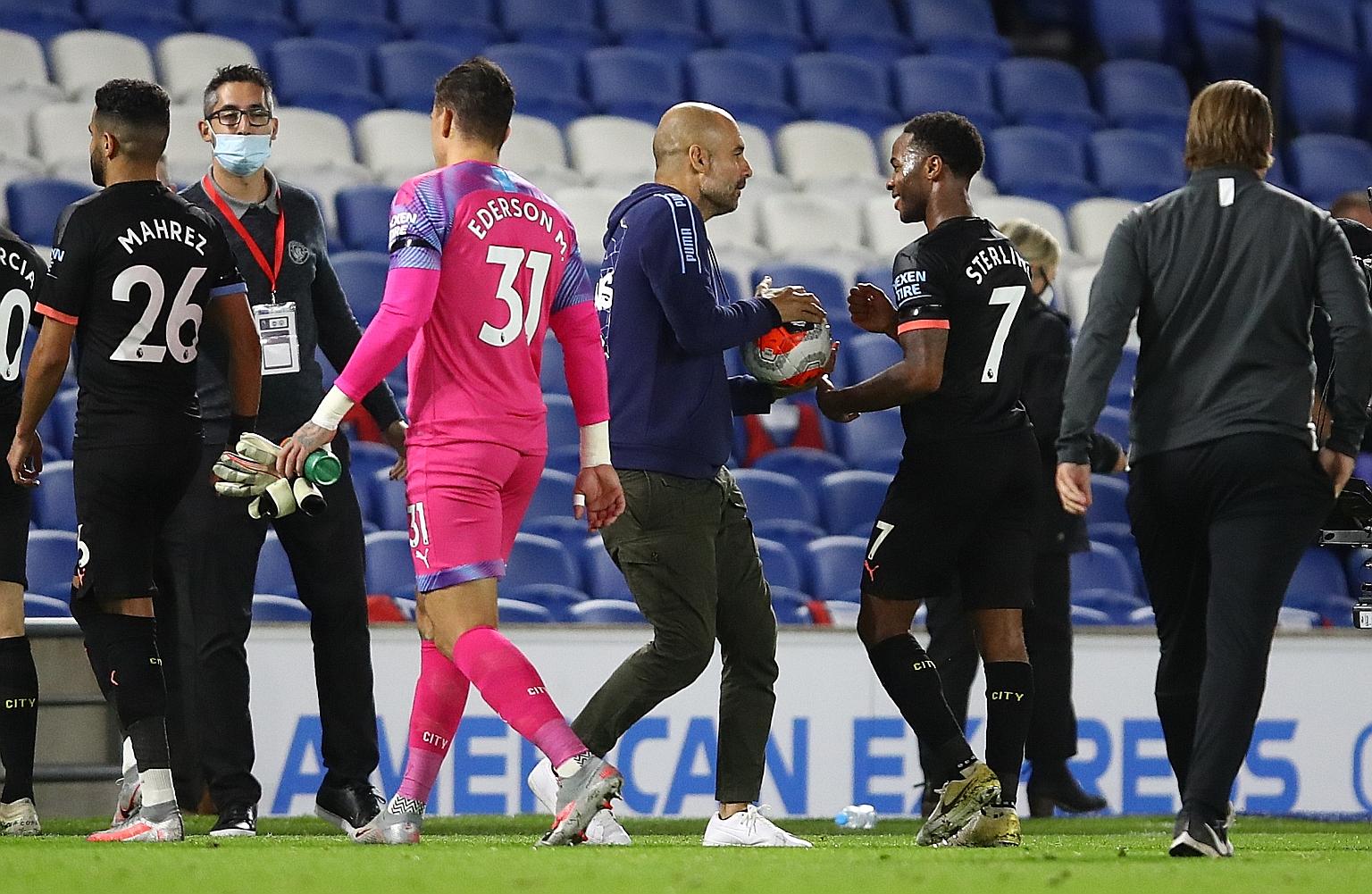 City boss Pep Guardiola handing the match ball to a joyous Raheem Sterling for his hat-trick in the 5-0 Premier League win over Brighton. 