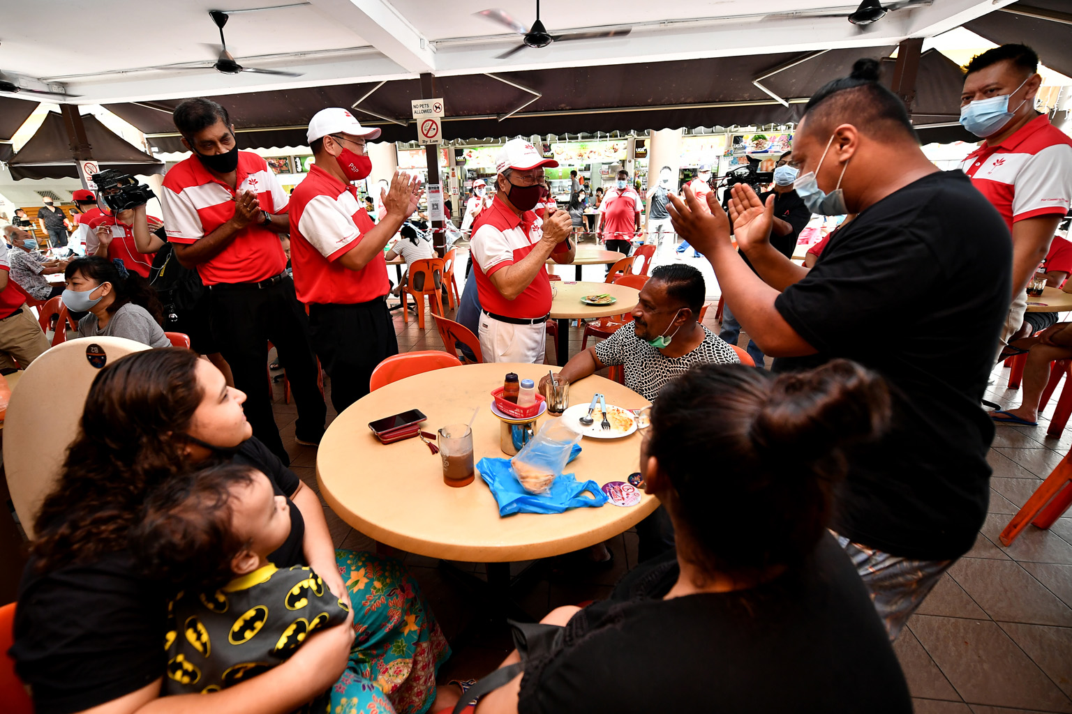 Right: Progress Singapore Party's West Coast GRC team members (from left) Nadarajah Loganathan, Jeffrey Khoo and Tan Cheng Bock greeting residents at a coffee shop in Teban Gardens yesterday. ST PHOTO: LIM YAOHUI