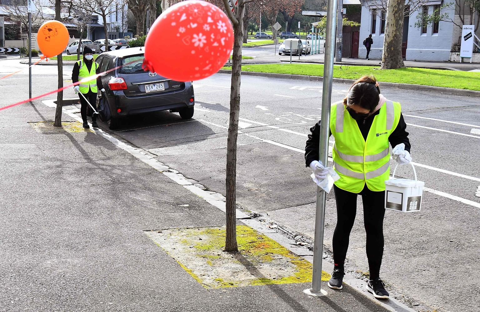 A cleaner wiping down a pole outside a public housing estate under lockdown in Melbourne. Yesterday, the authorities in Victoria reported 177 new coronavirus cases in the past 24 hours, the eighth consecutive day that the state has seen triple-digit 