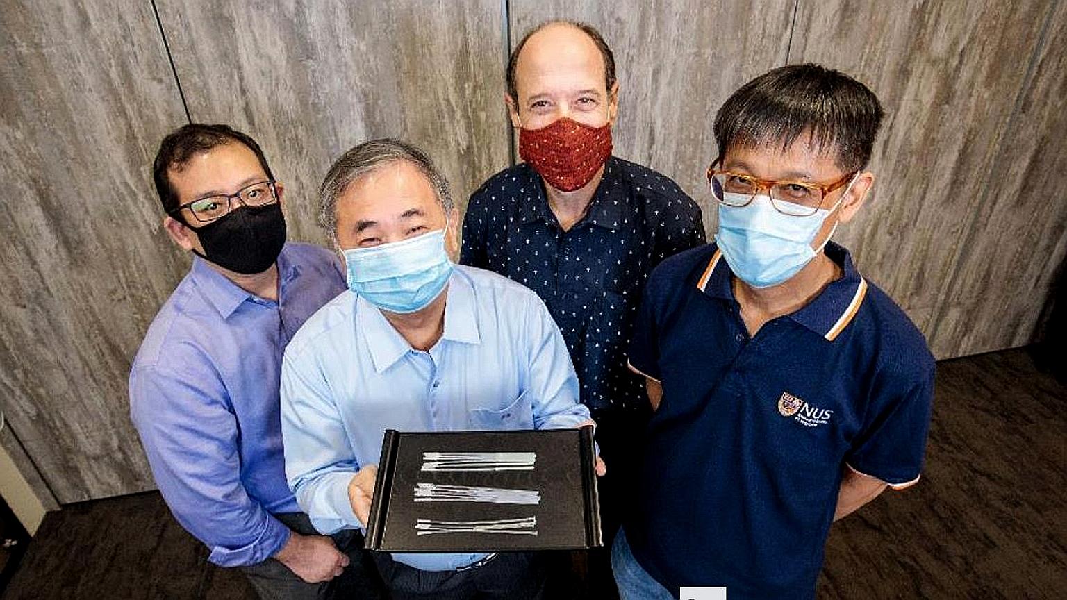 Professor Freddy Boey with the swabs. With him are (from left) Dr Alfred Chia, Associate Professor David Allen and Associate Professor Yen Ching-Chiuan. They are part of two National University of Singapore teams that came up with three nasopharyngea