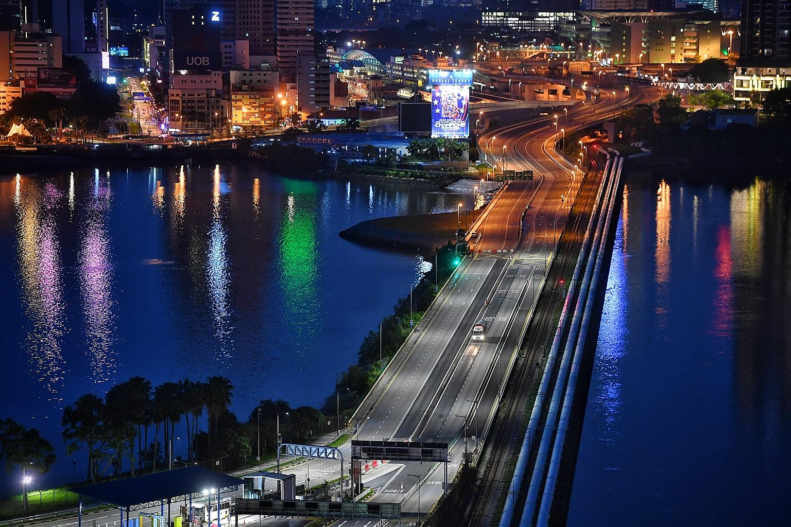 Travel curbs have left the Johor-Singapore Causeway largely empty, as seen in a photo taken from Woodlands in May. Before Covid-19 restrictions were in place, over 300,000 people, many of them Malaysians working in Singapore, crossed the land checkpo