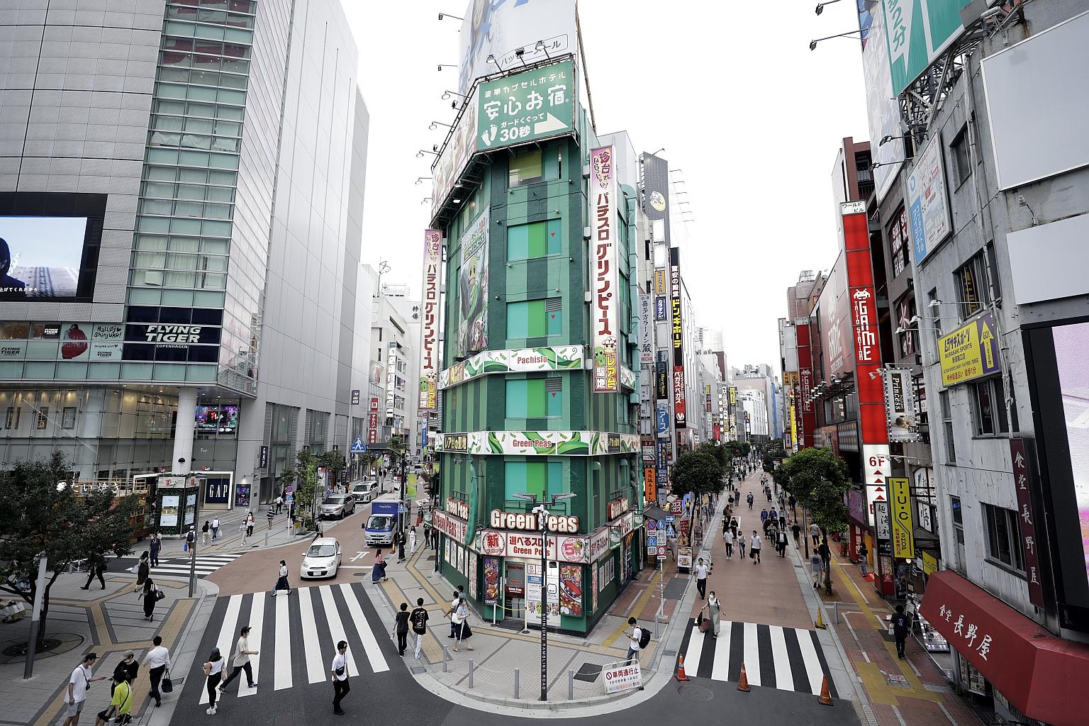 The latest cluster has been traced to the 190-seat Theatre Moliere in Shinjuku (above), a busy entertainment area and home to one of Asia's biggest red-light districts, which has been the centre of a recent spike in infections. PHOTO: BLOOMBERG