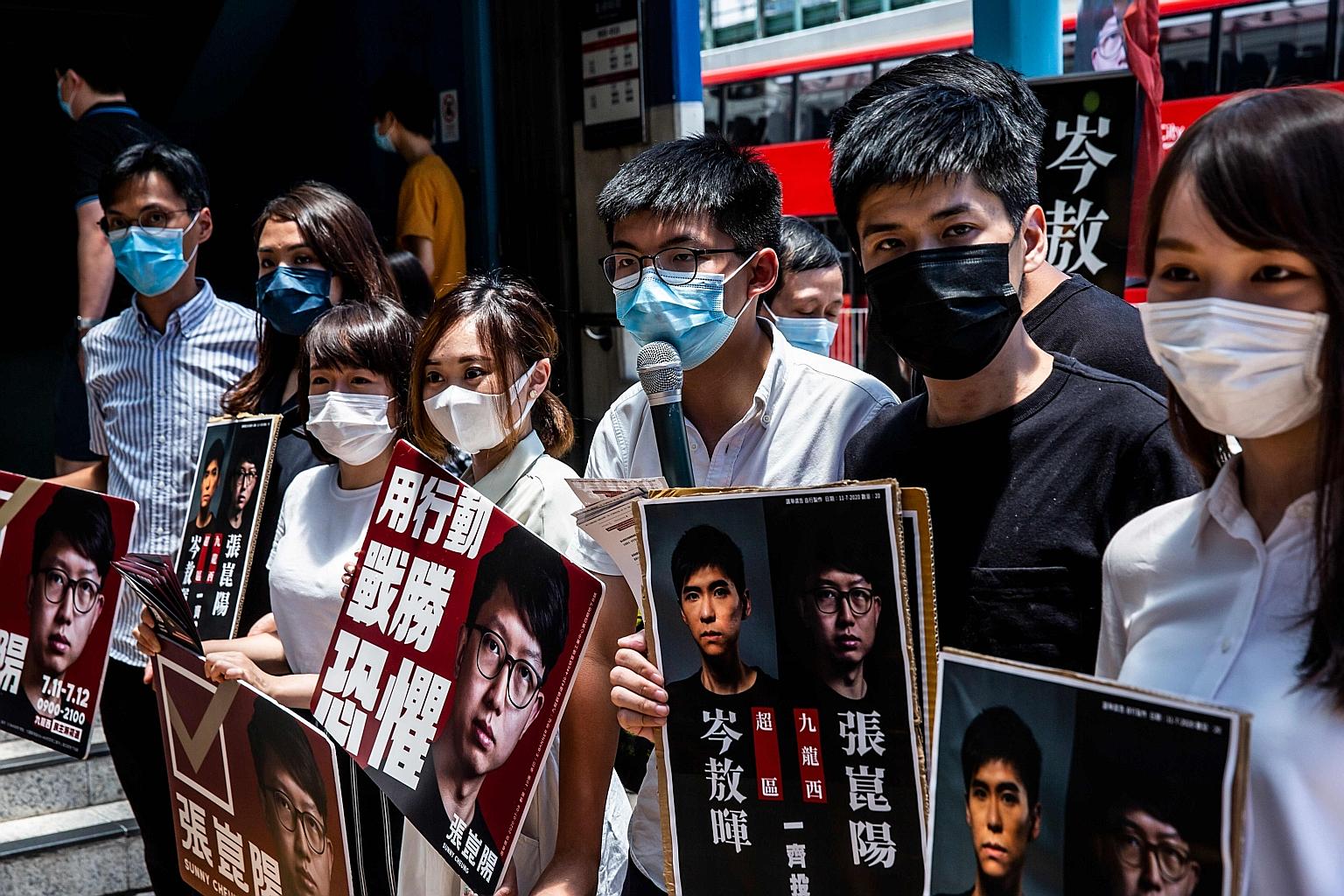Pro-democracy activists (from left) Eddie Chu, Gwyneth Ho, Leung Hoi Ching, Tiffany Yuen, Joshua Wong, Lester Shum and Agnes Chow campaigning for the unofficial primaries in Hong Kong on Sunday. Mr Wong announced his win in Kowloon East district on s