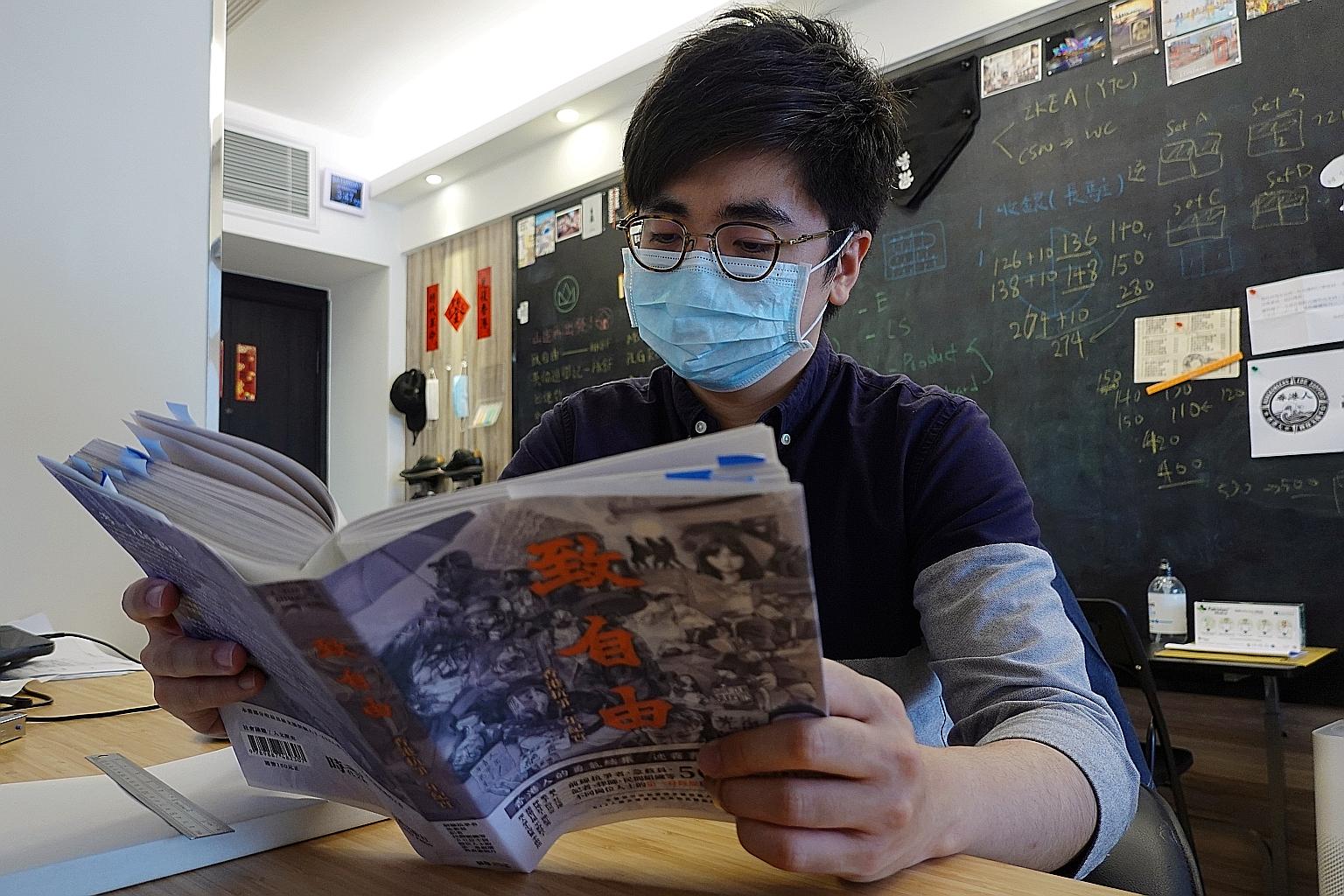 Publisher Raymond Yeung with a draft copy of To Freedom, with blue sticky flags on many pages to mark the changes he has made. PHOTO: REUTERS