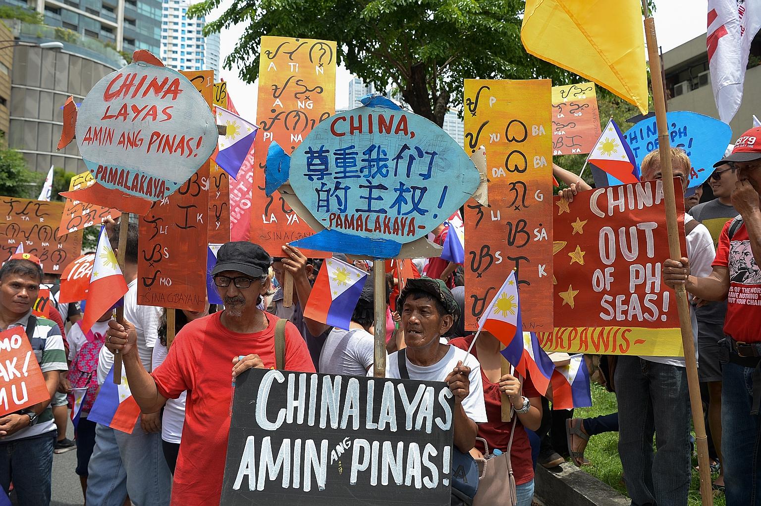Activists holding placards with anti-China slogans during a protest in front of the Chinese consulate in Manila last year. The Philippines is contesting China's claims over waters it considers part of its exclusive economic zone. China's vast claims 